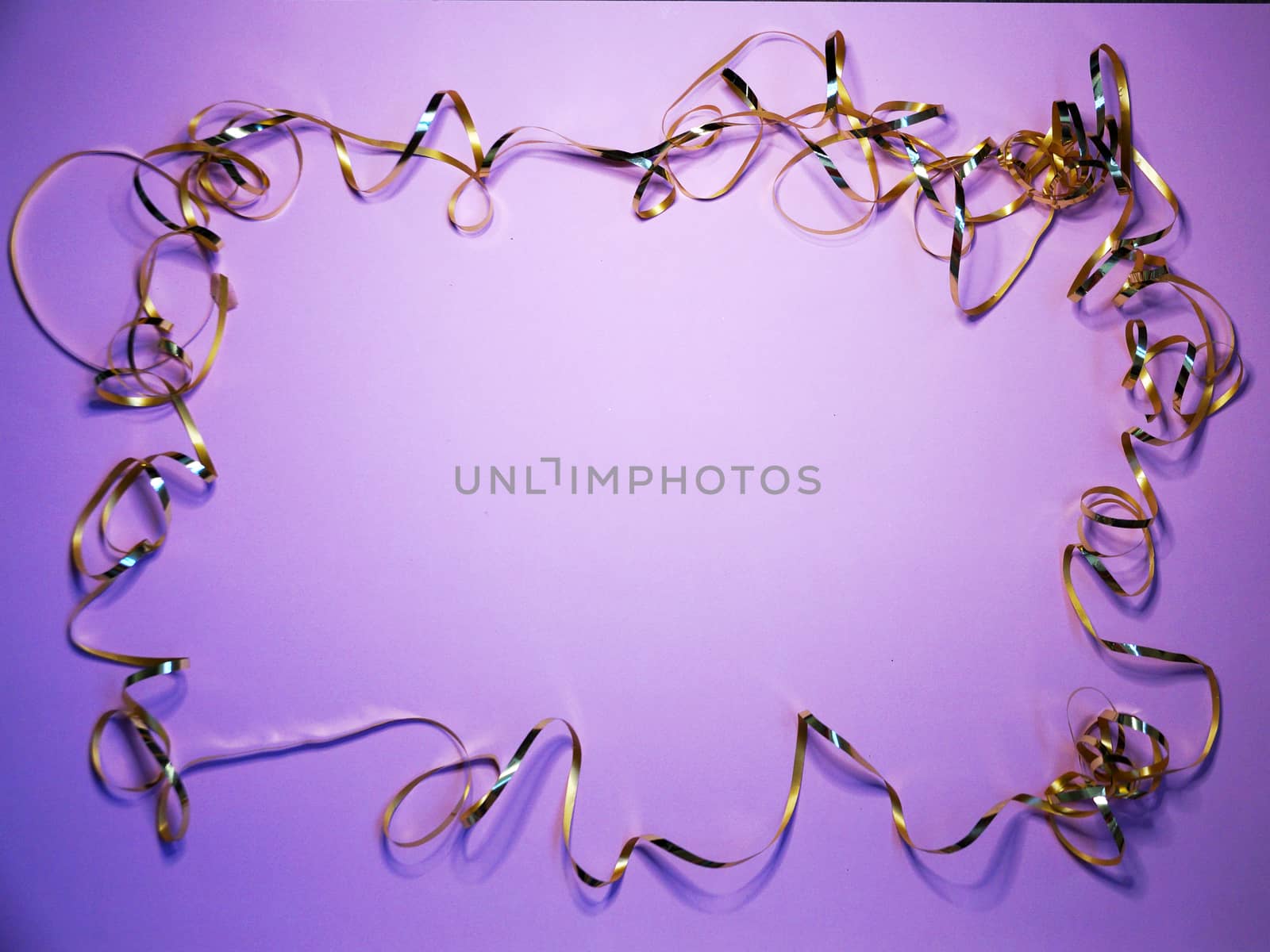 wavy golden ribbon frame on lilac background, copy space for new year, christmas.