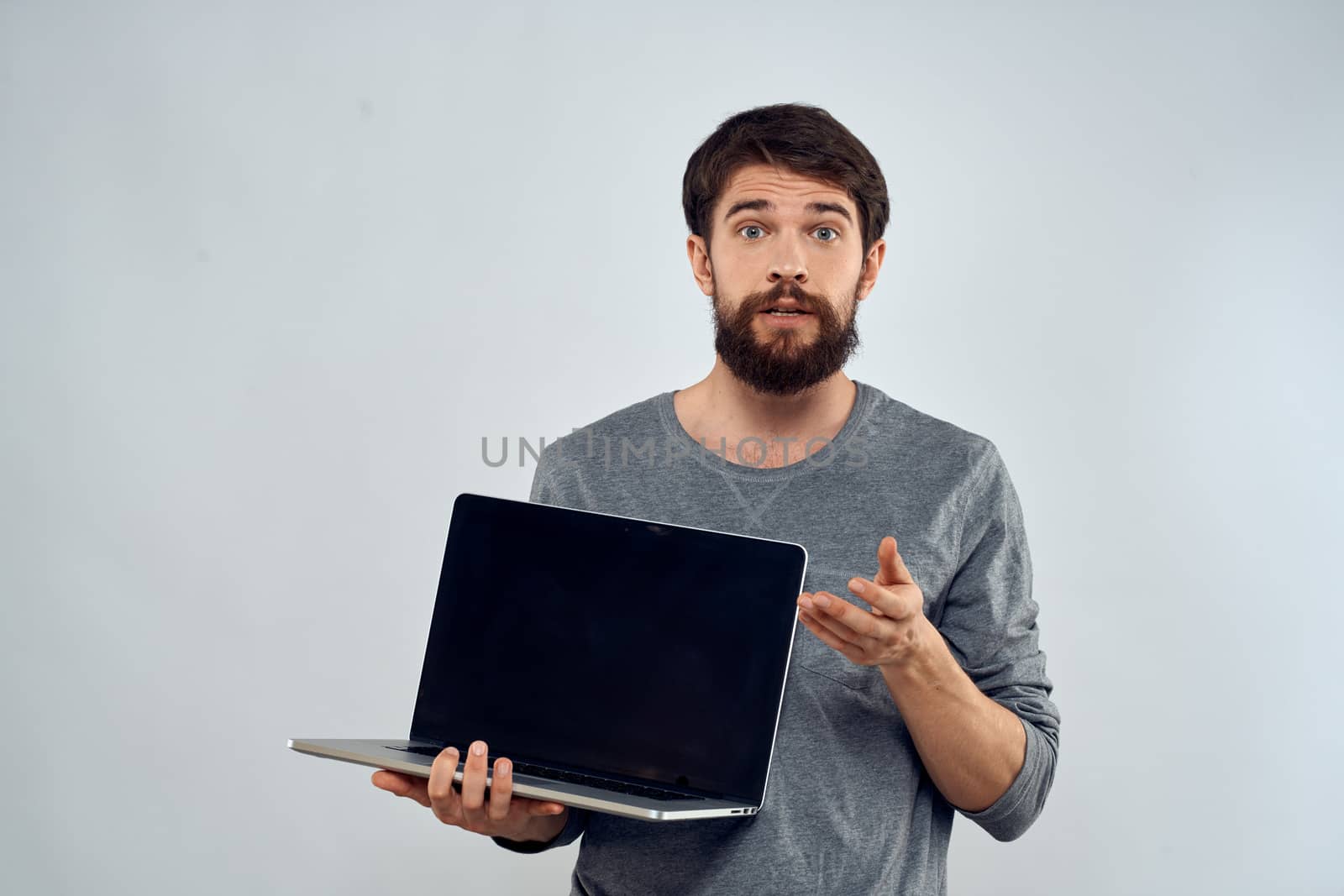 man holding laptop technology internet work communication light background by SHOTPRIME