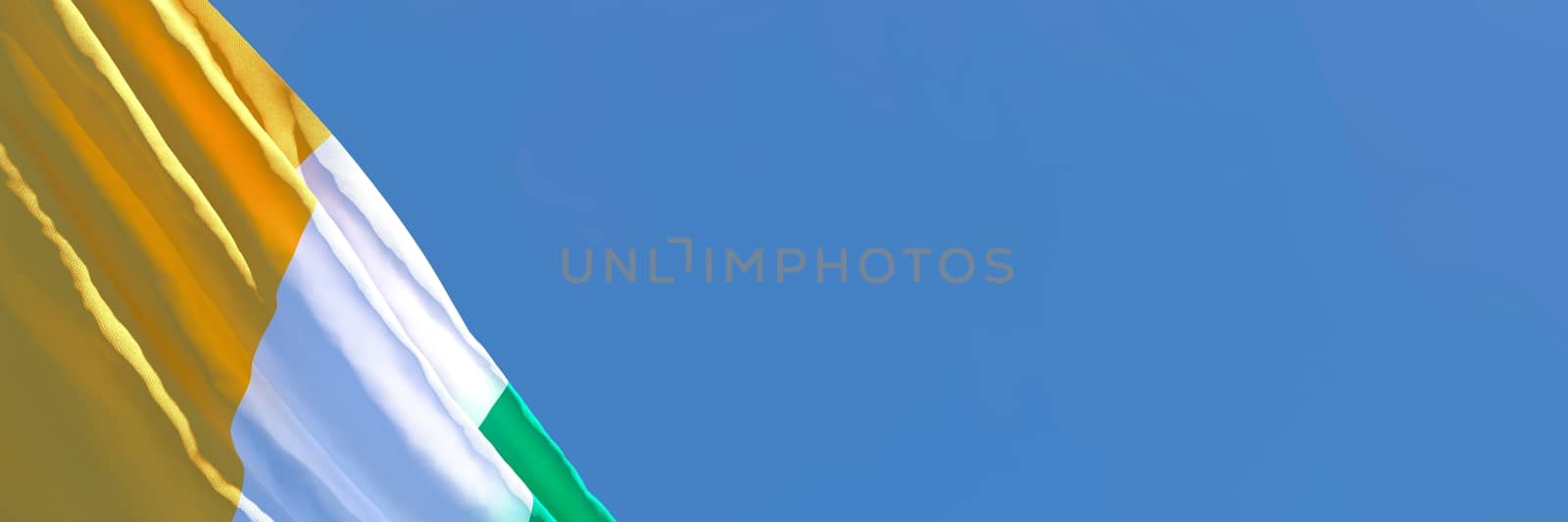 3D rendering of the national flag of Cote dIvoire waving in the wind against a blue sky