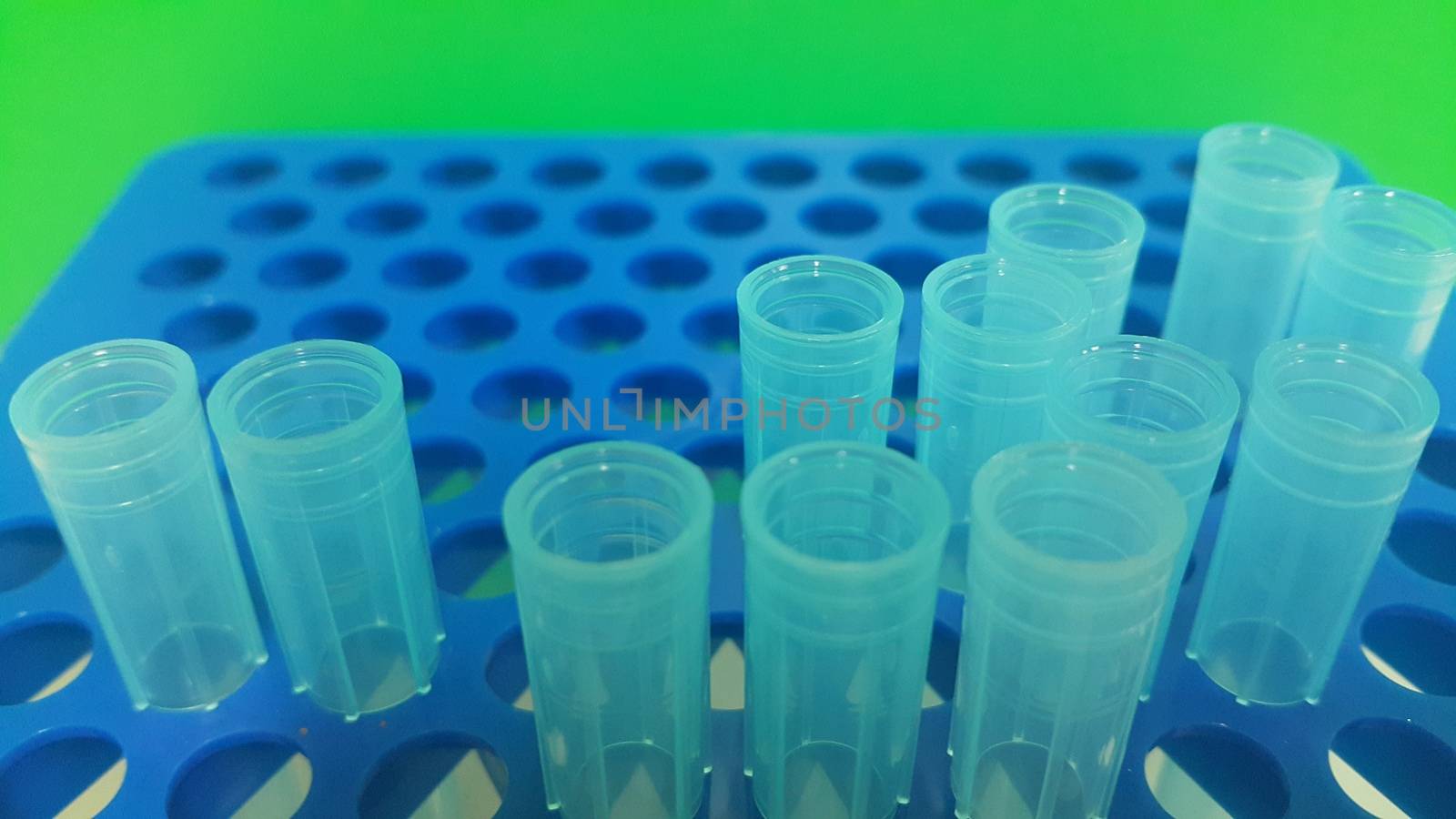 Close up view of blue micro litre tips in microtip box with empty holes. Reseach lab. tool for accurate measurement.