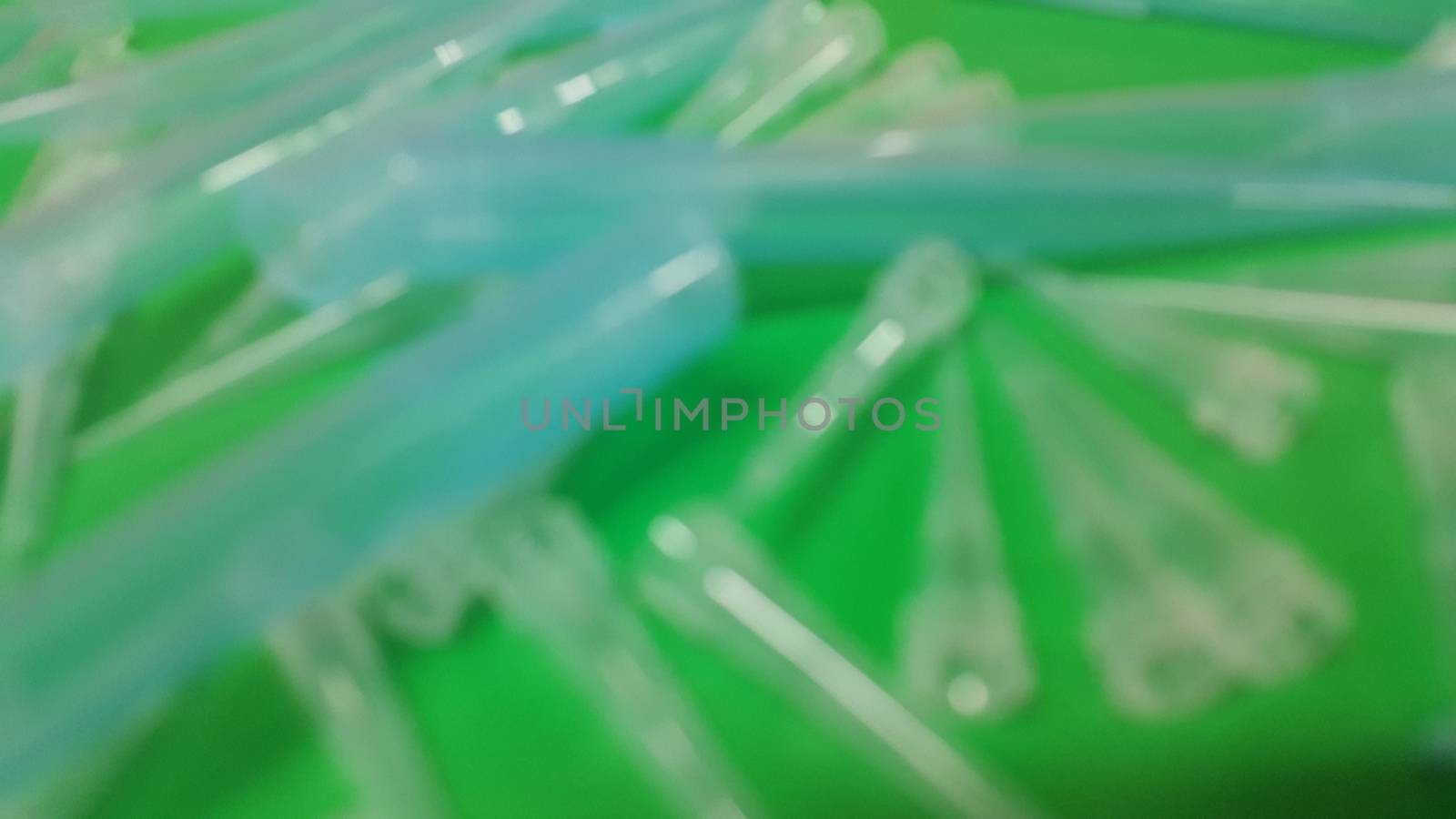 Close up view of micro litre tips on green floor sheet with empty holes. Reseach lab. tool for accurate measurement.