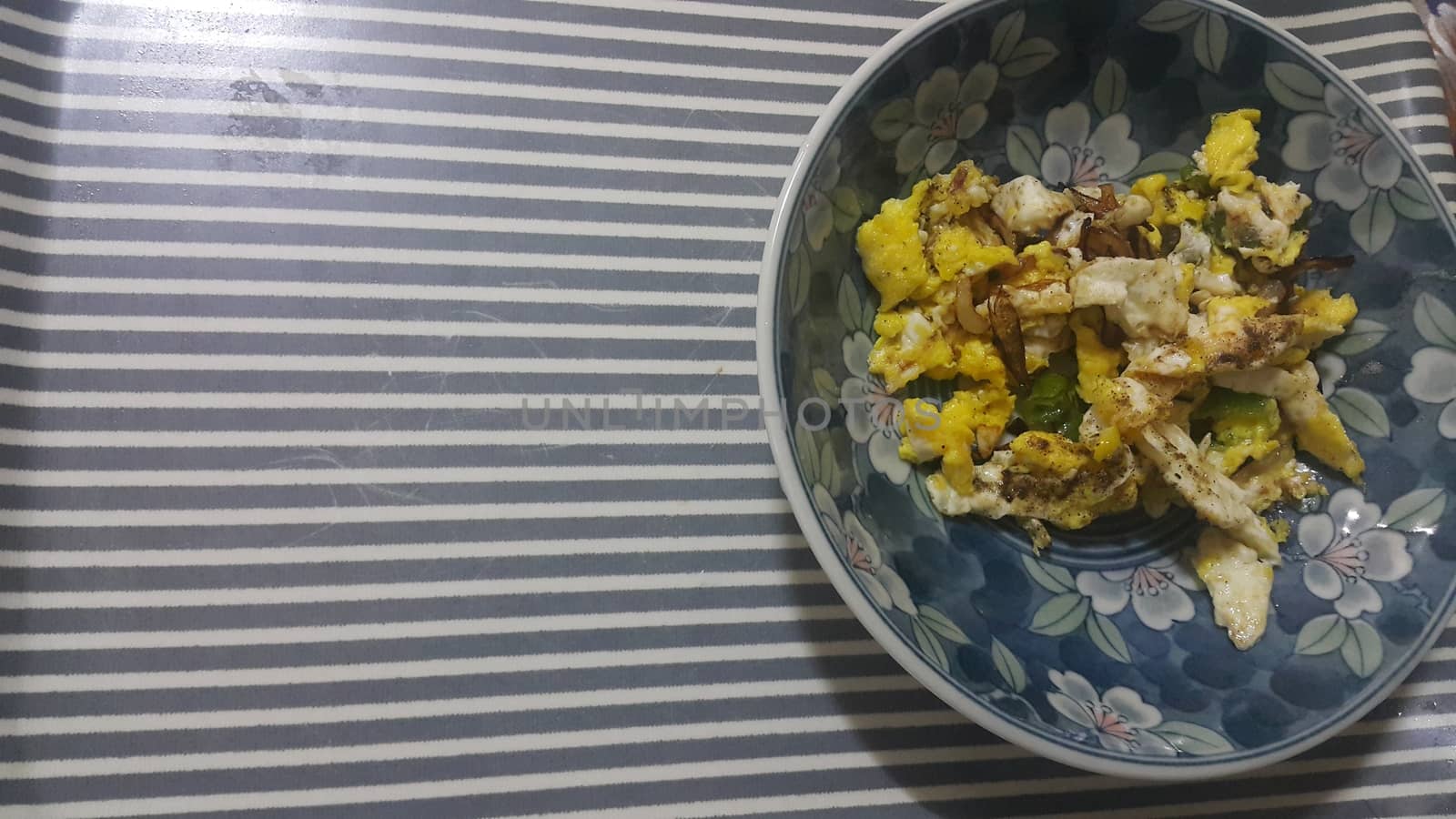 Closeup view of fried egg omelet dish in a fry pan. Home made egg omelet is served in breakfast.