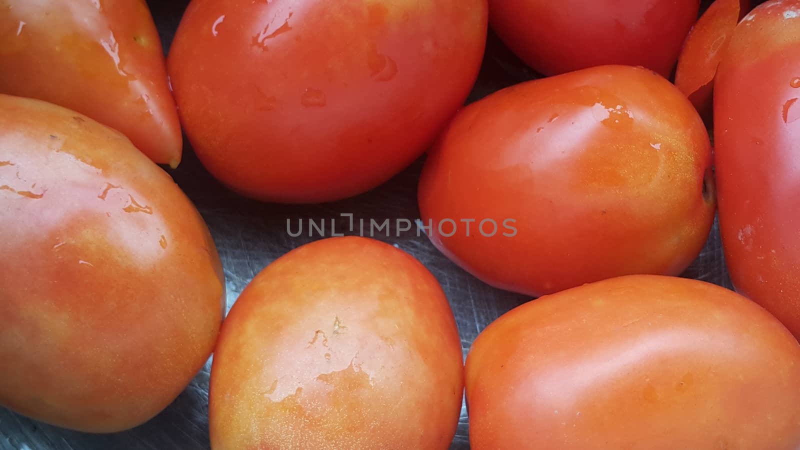 Red tomatoes in super market for sale. A background for text and advertisements