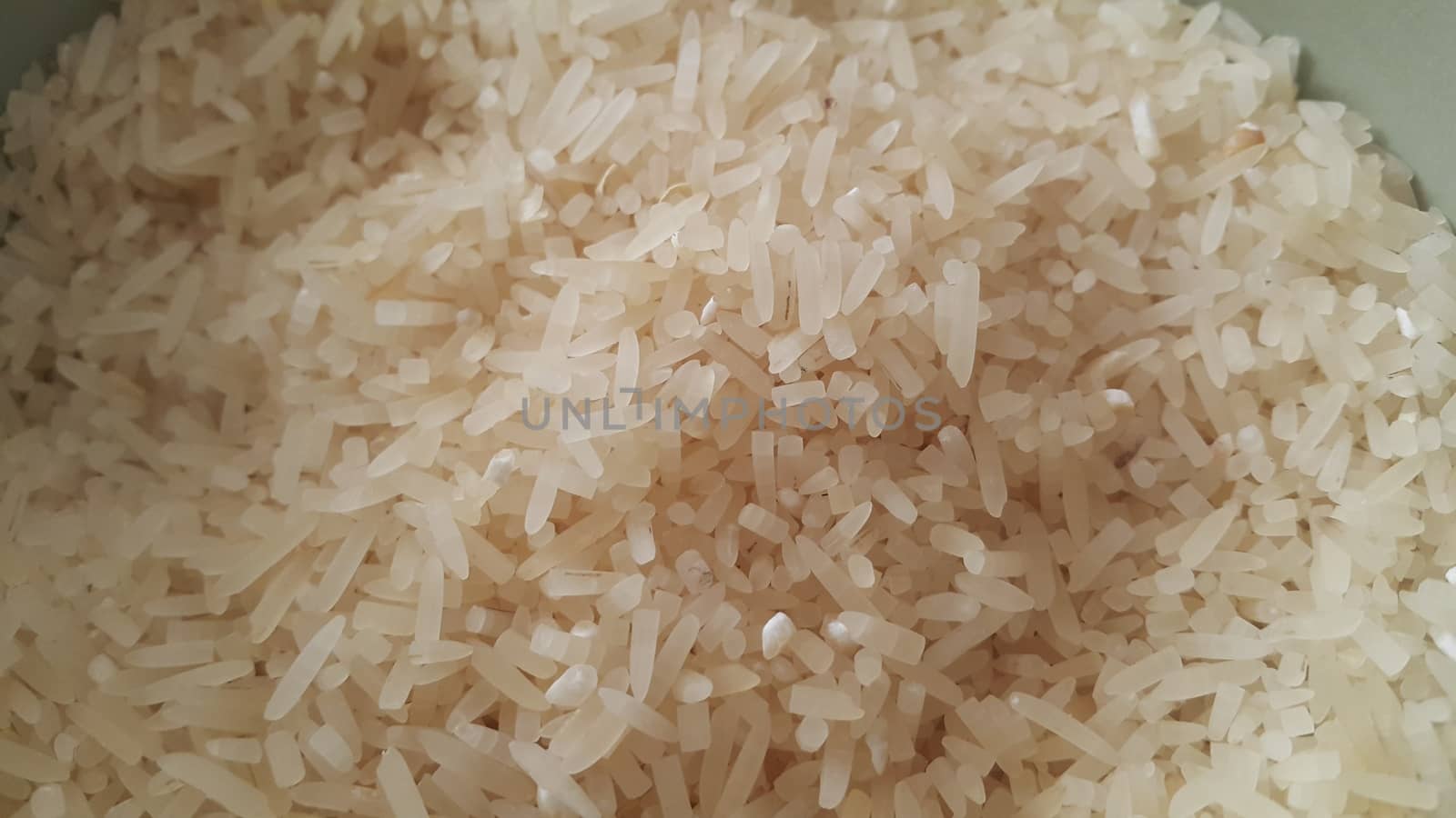 Top closeup view of heap of rice. Rice is the most consumed food ingredient in the world