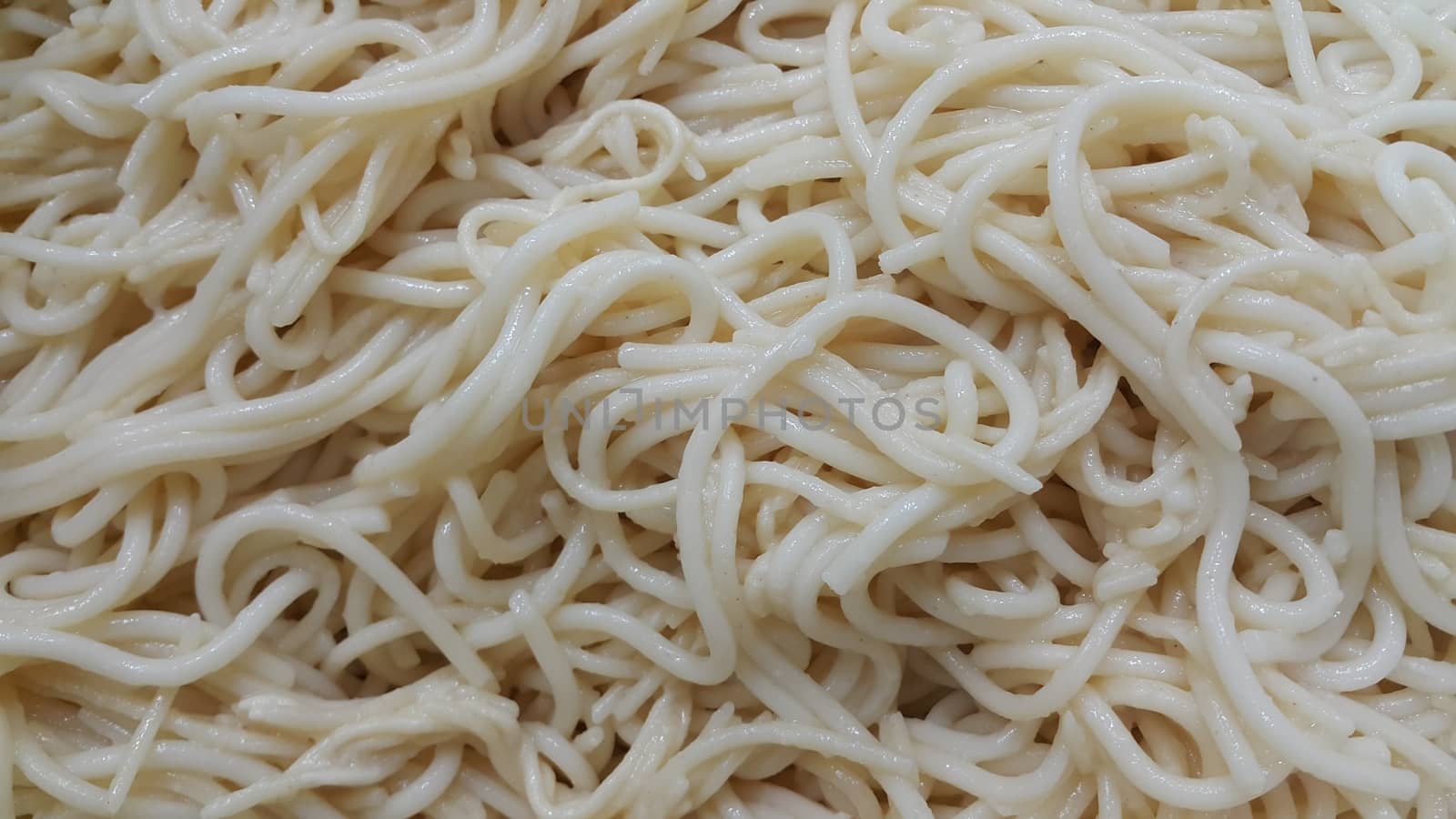 close up view of swirling noodles or spaghetti pasta for eating. Food background for fast foods