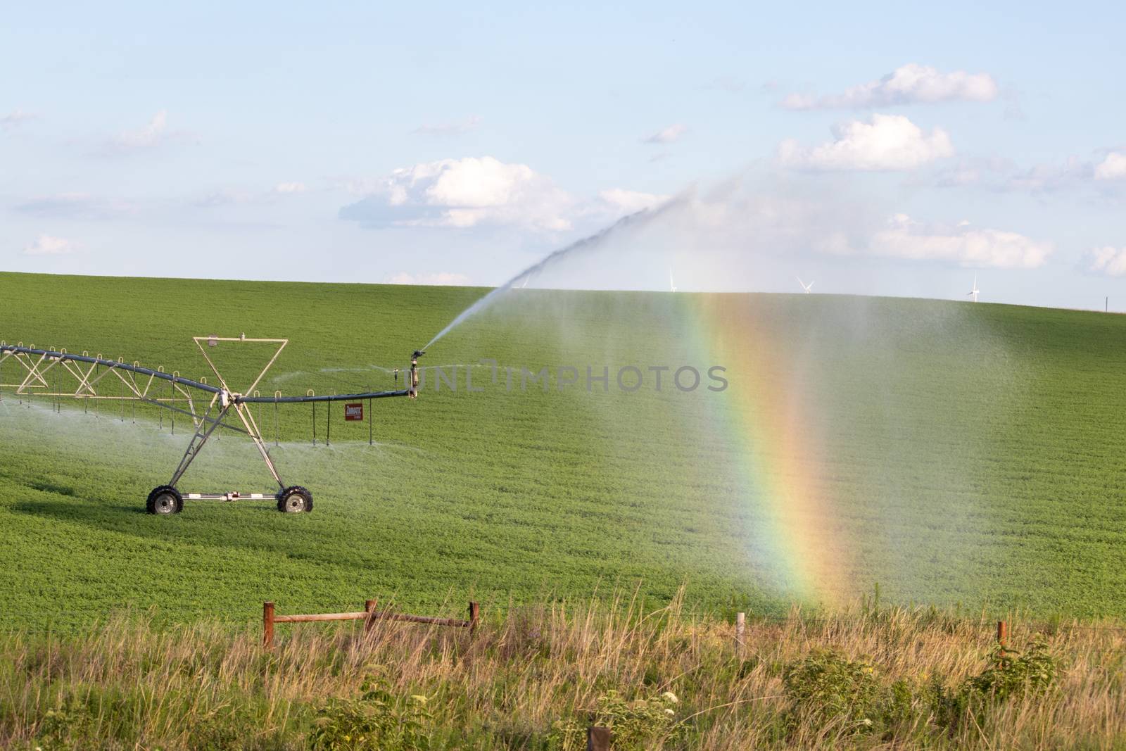 Pivot running in field with beautiful rainbow on sunny day . July 22, 2019, O'Nell, Holt county, Nebraska by gena_wells