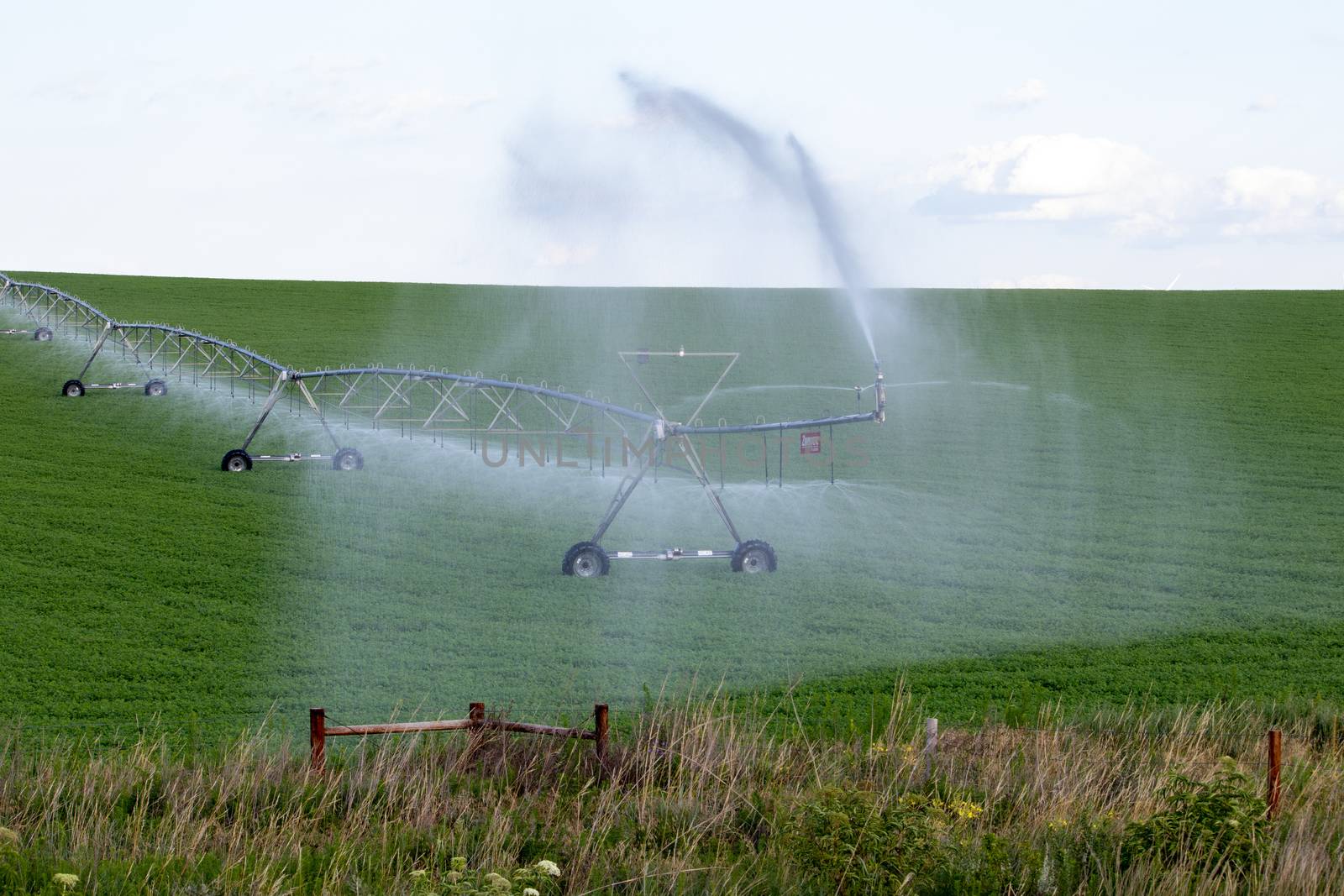 Pivot running in field with beautiful rainbow on sunny day . July 22, 2019, O'Nell, Holt county, Nebraska by gena_wells