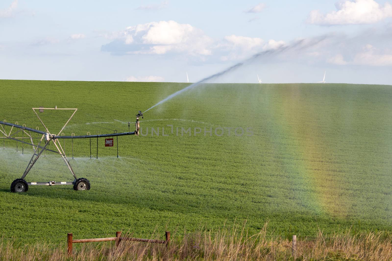 Pivot running in field with beautiful rainbow on sunny day . July 22, 2019, O'Nell, Holt county, Nebraska by gena_wells