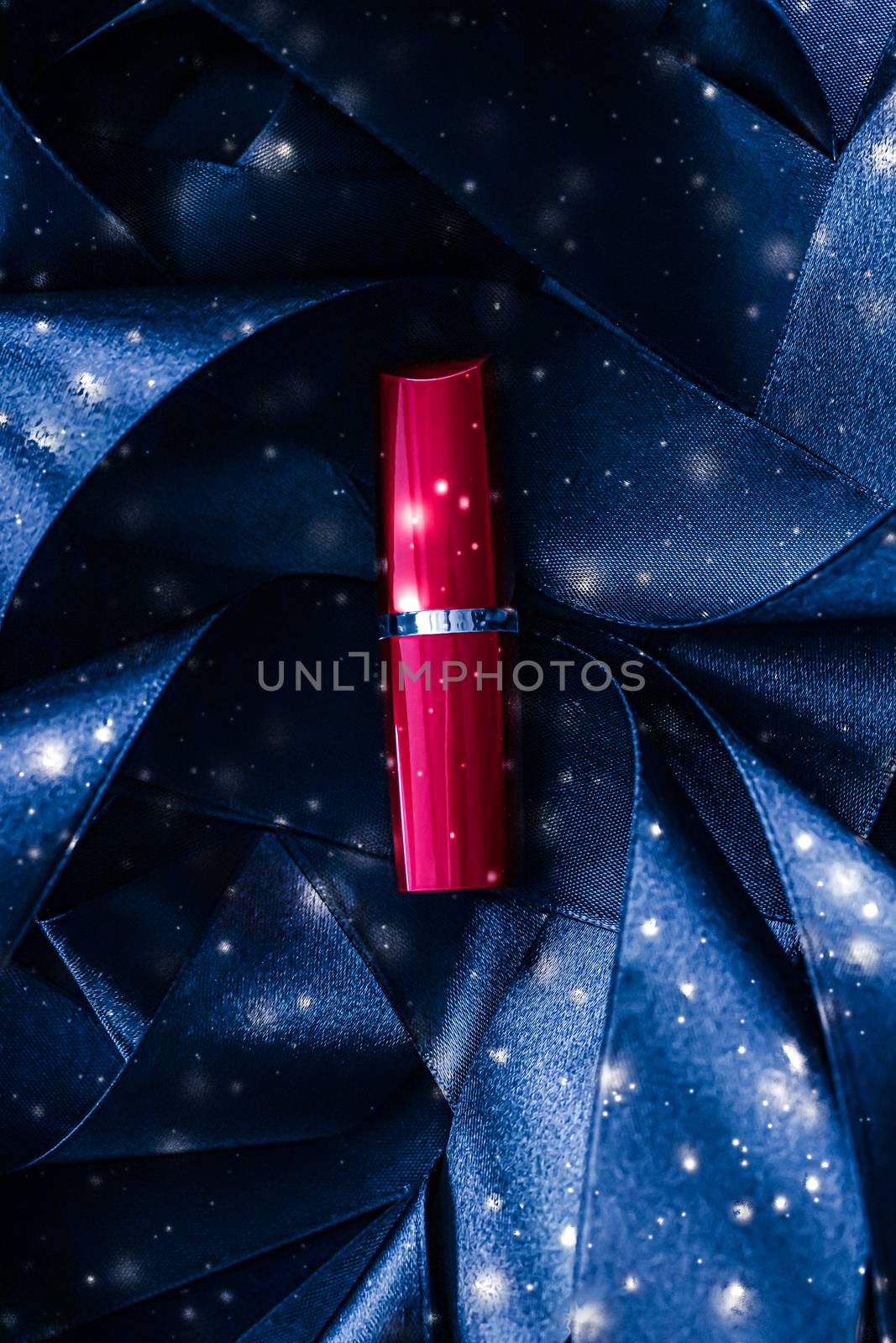 Red lipstick on blue silk and shiny glitter background, luxury make-up and beauty cosmetic by Anneleven