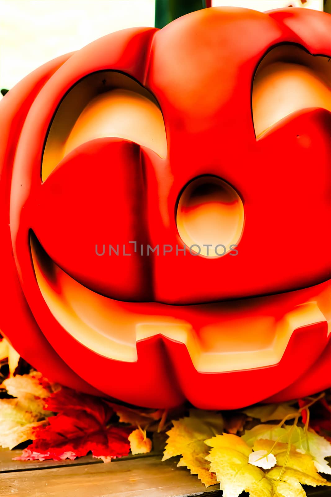 Halloween decorations concept.Close up of Jack O'lantern, vintage lanterns, pumpkins, skull, autumn leaves. Colorful Halloween. Happy Halloween scene background by USA-TARO