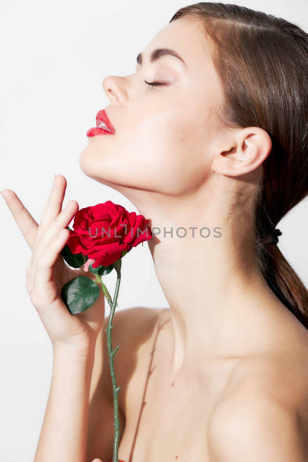 Girl with bare shoulders Eyes closed rose charm attractive look background