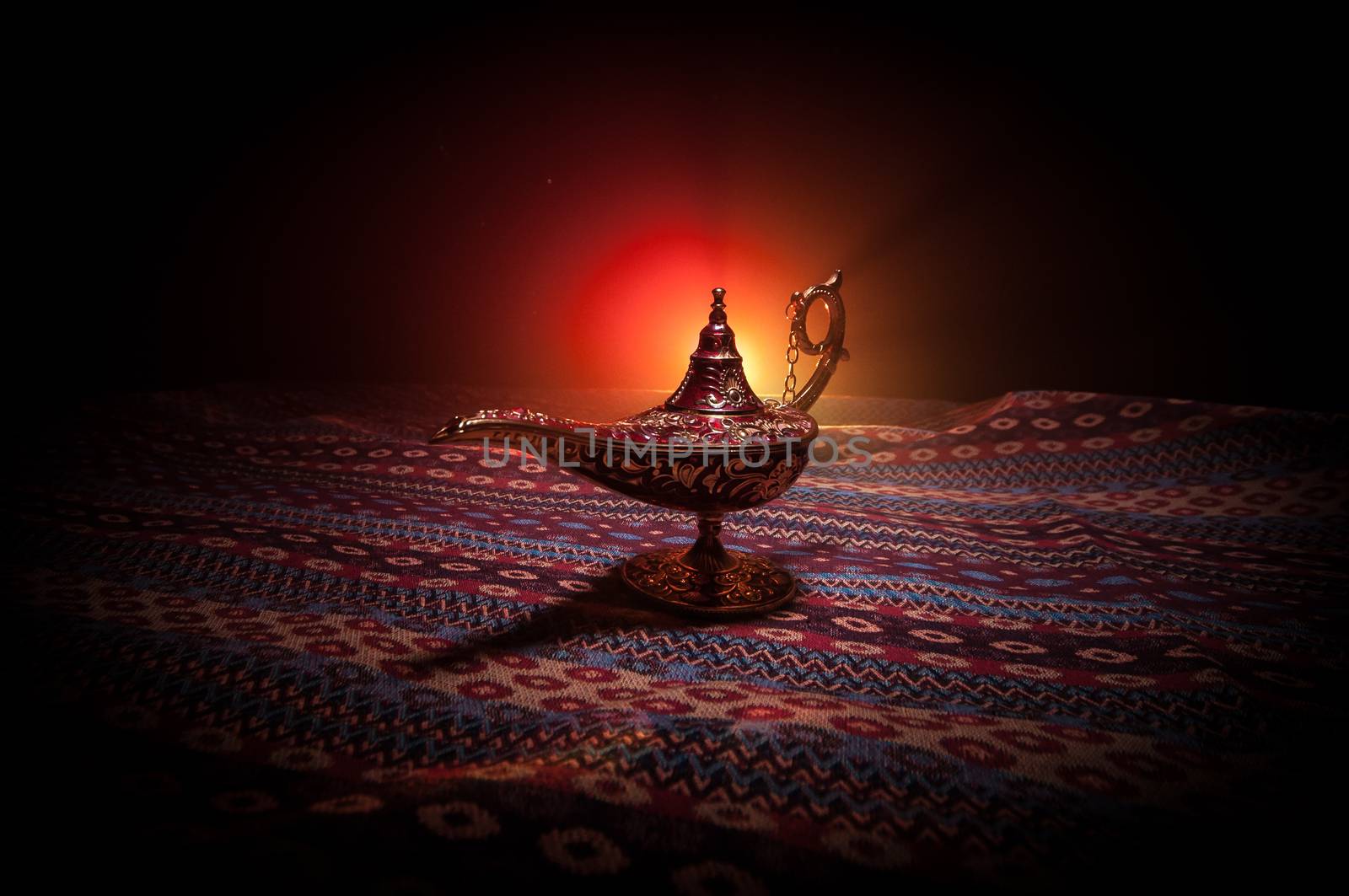Antique Aladdin arabian nights genie style oil lamp with soft light white smoke, Dark background. Lamp of wishes concept