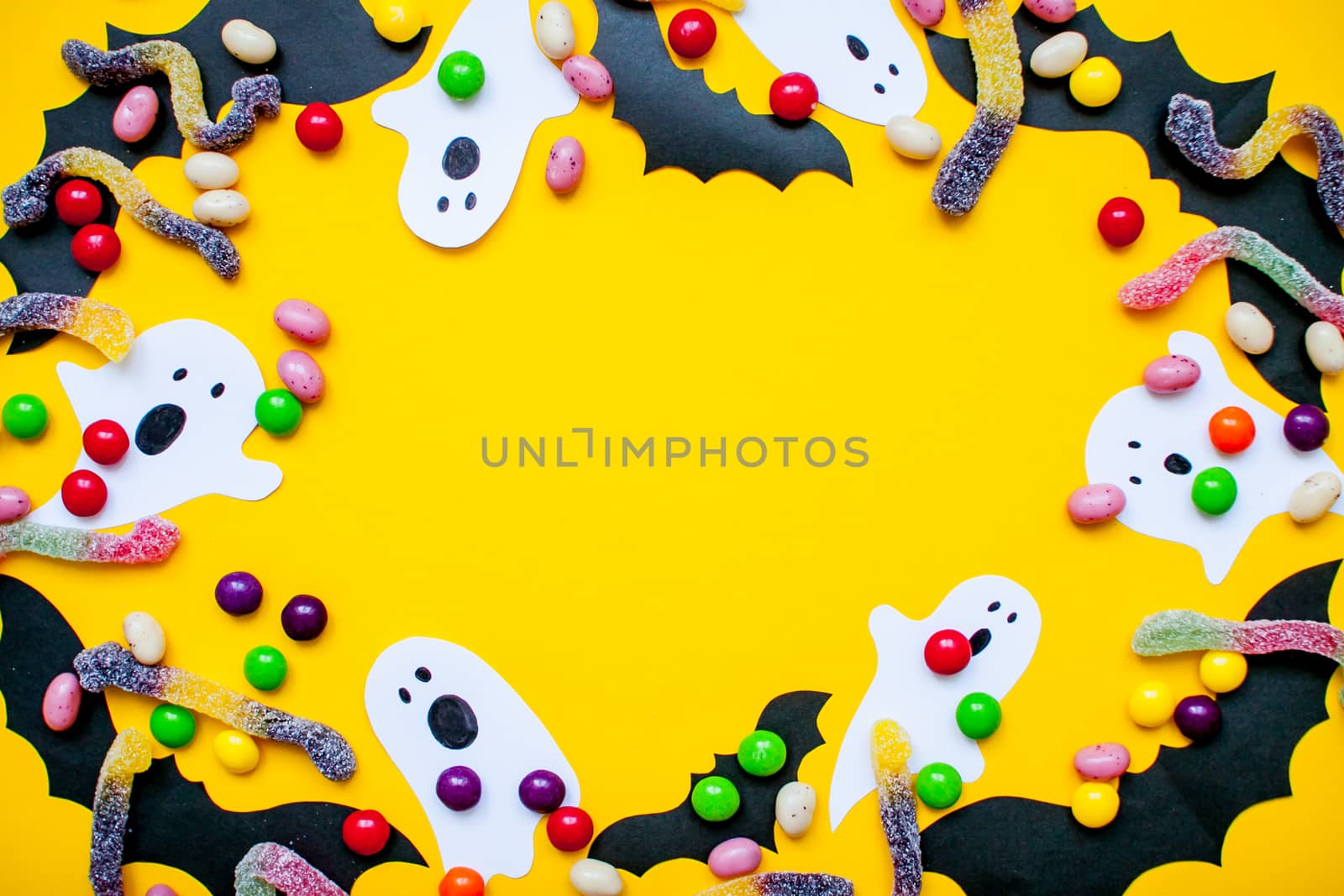 frame made of paper homemade bats and paper ghosts and of multicolored candies and worms from gummy by malyshkamju