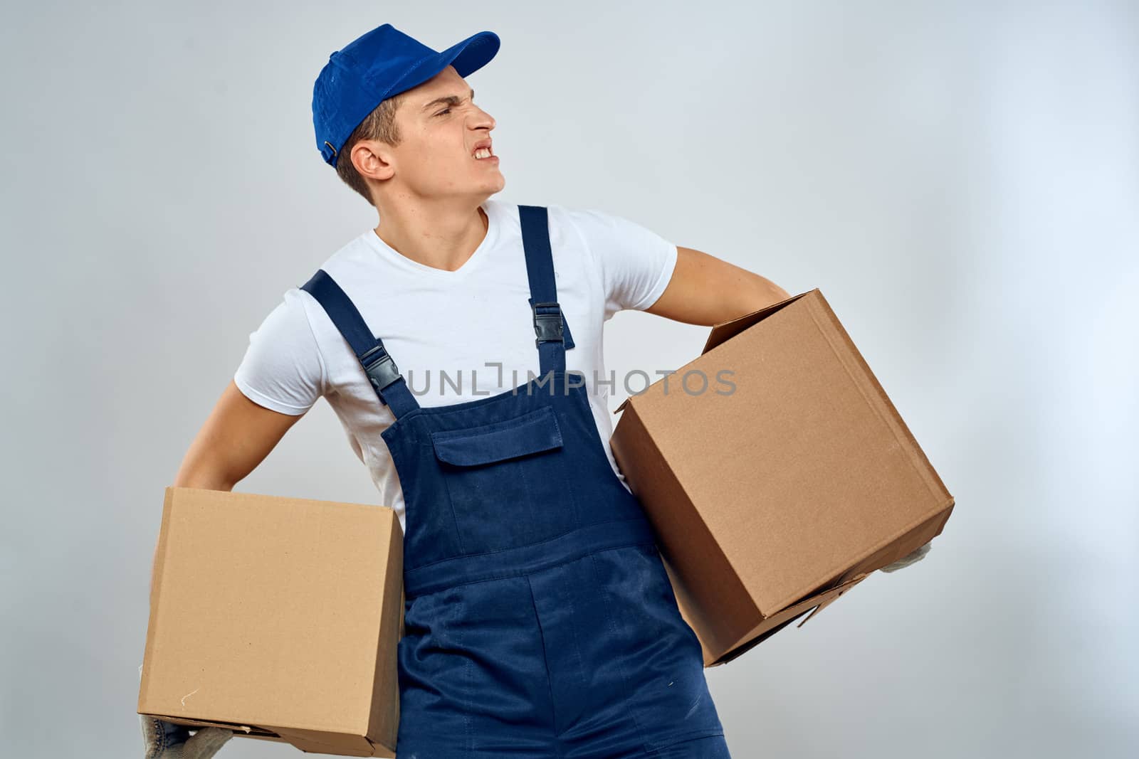 Man worker with box in hands delivery loading service packing service. High quality photo