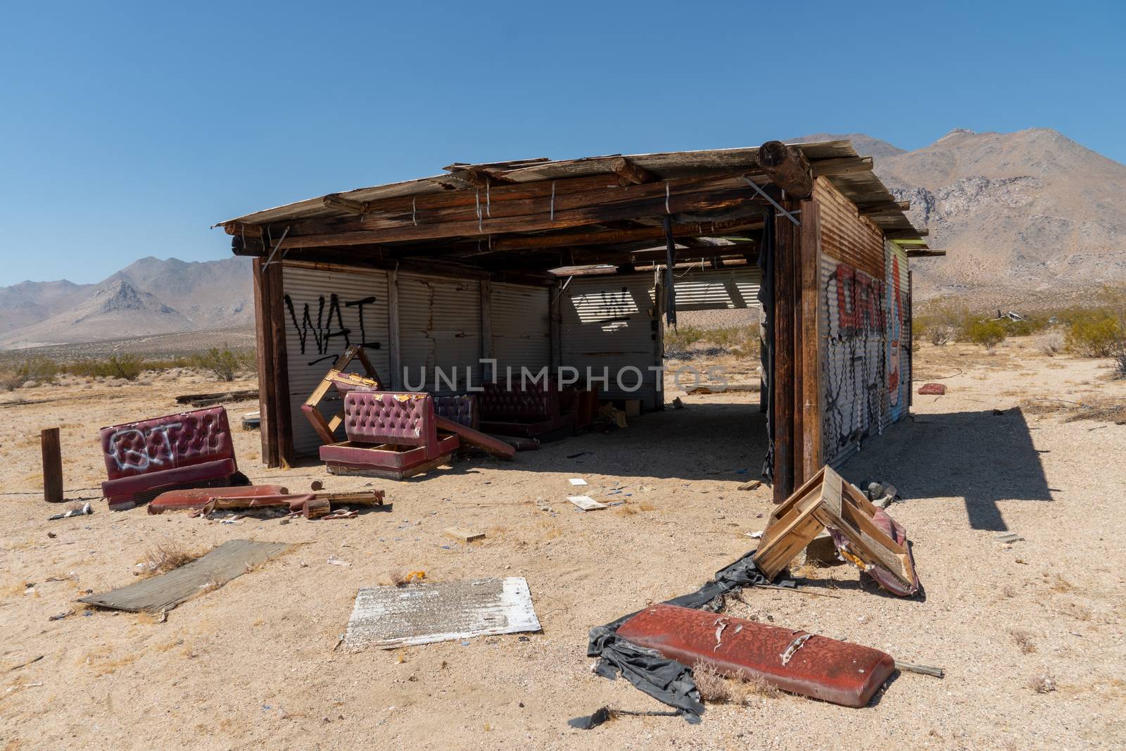 Abandoned houses and camper trailer in the middle of the desert by Bonandbon