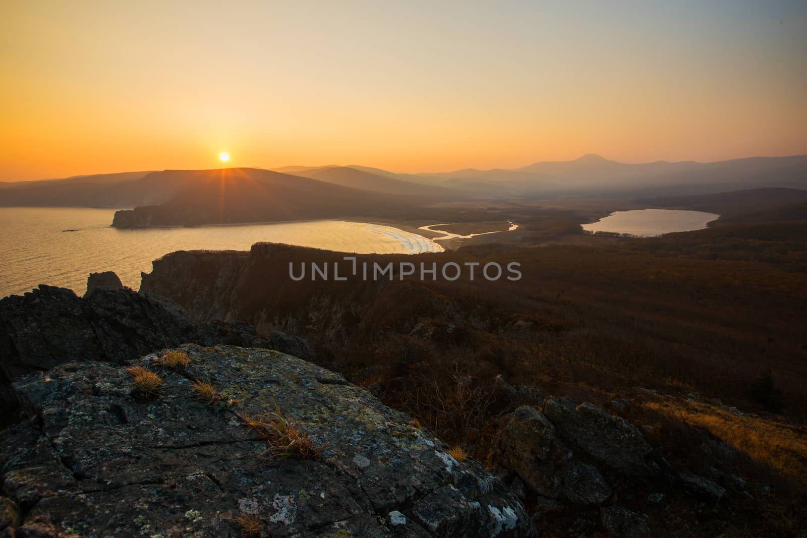 View from above. A beautiful sunset in the Sikhote-Alin Biosphere Reserve in the Primorsky Territory. Golden autumn in the wild