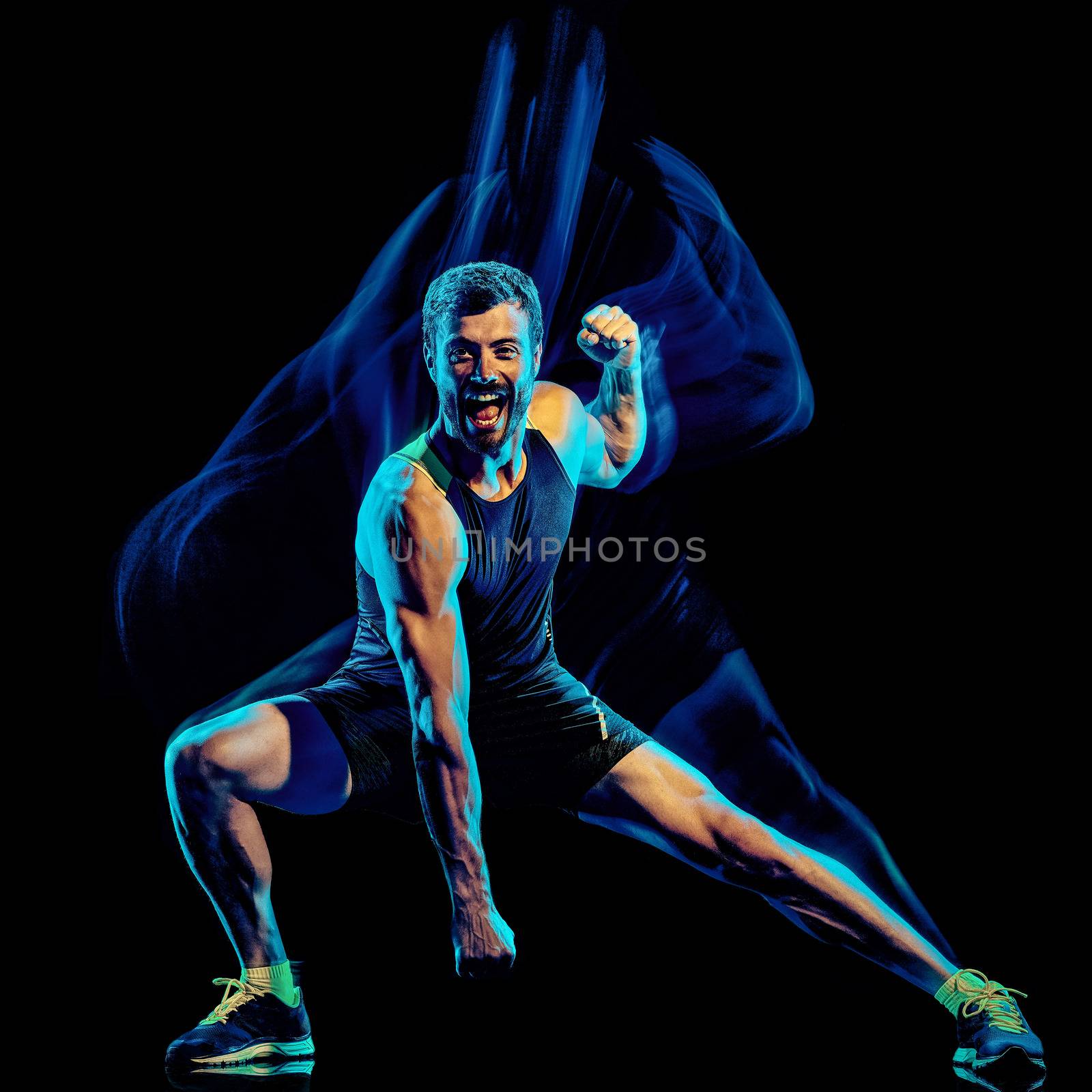 one caucasian player man exercising fitness cardio boxing exercise body combat studio shot isolated on black background with light painting blur effect