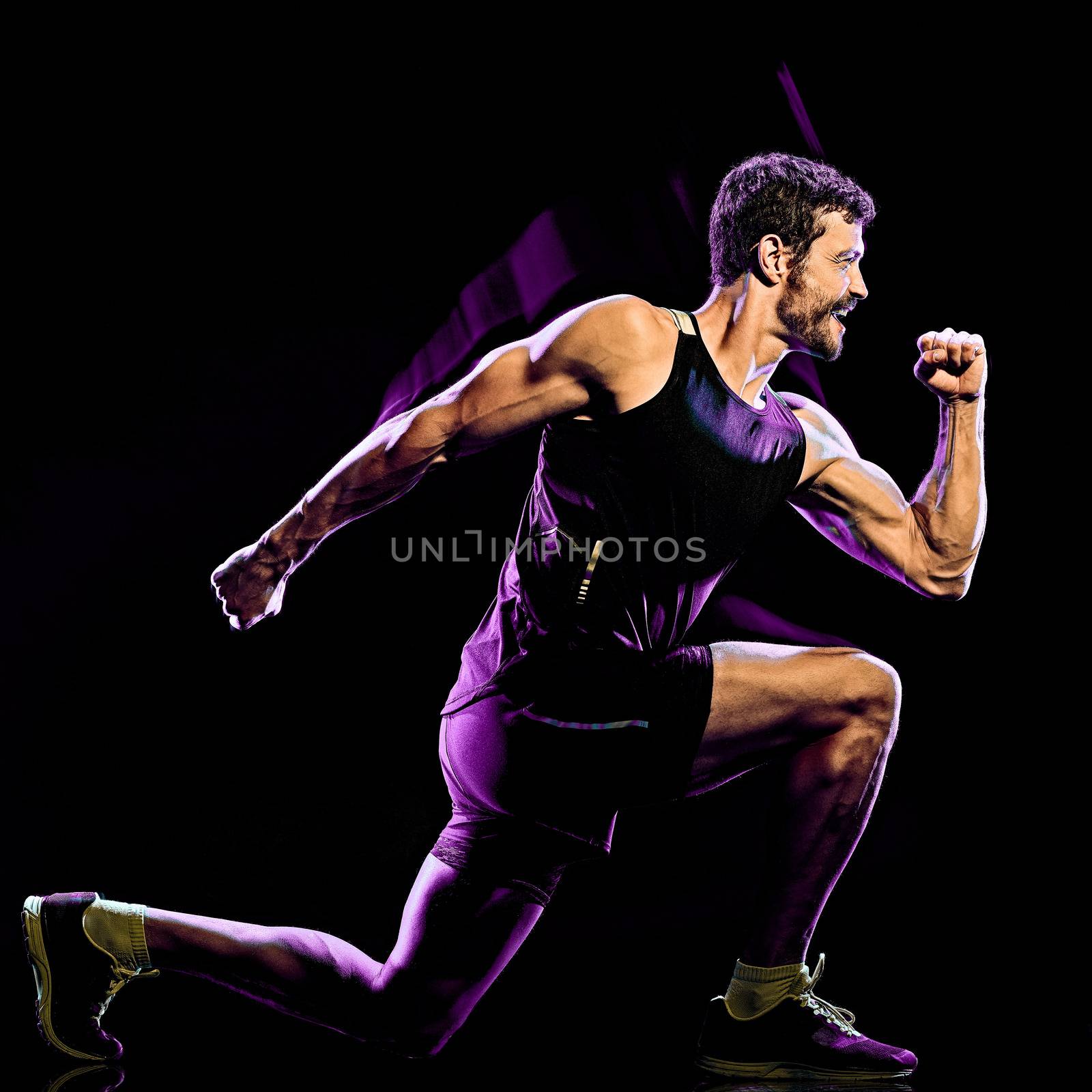 one caucasian player man exercising fitness cardio boxing exercise body combat studio shot isolated on black background with light painting blur effect