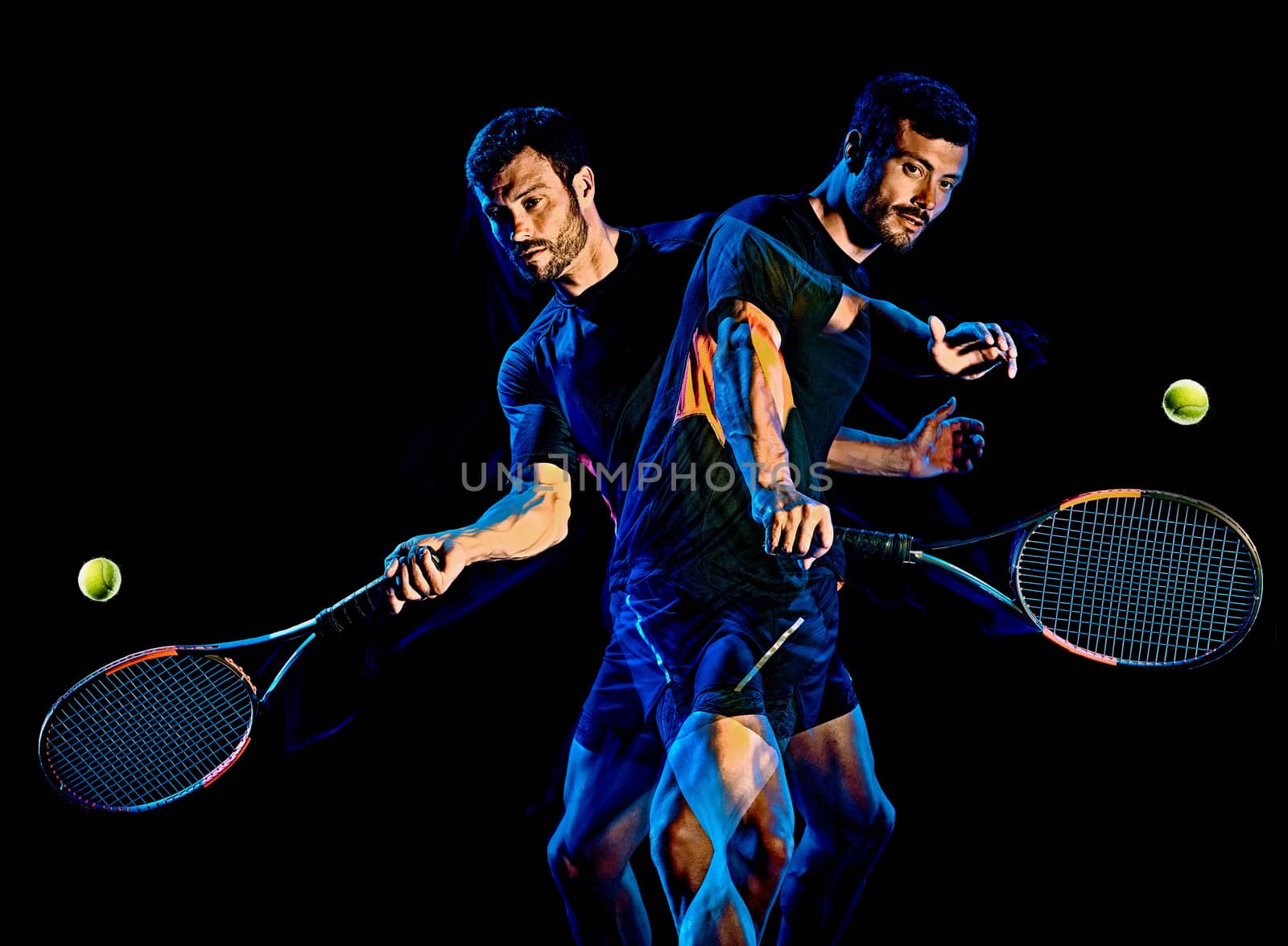 one caucasian Tennis player man studio shot isolated on black background with light painting blur effect