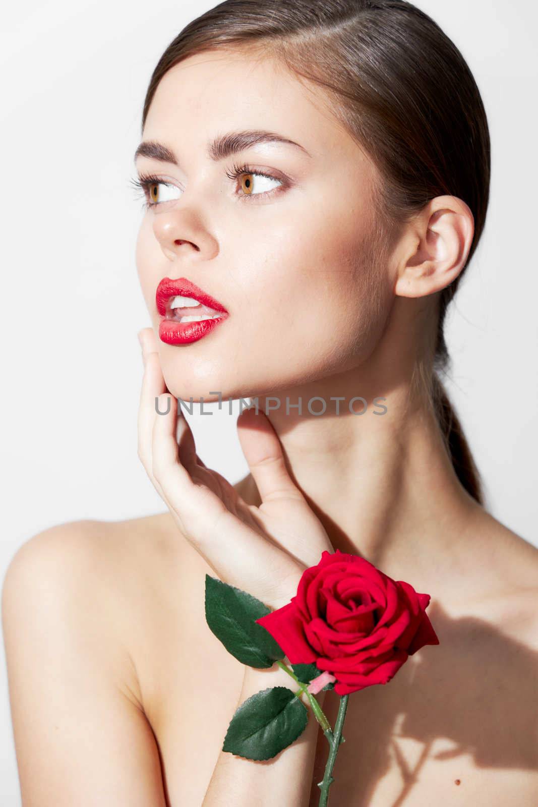 Girl with bare shoulders Model looks towards red lips body care cropped view