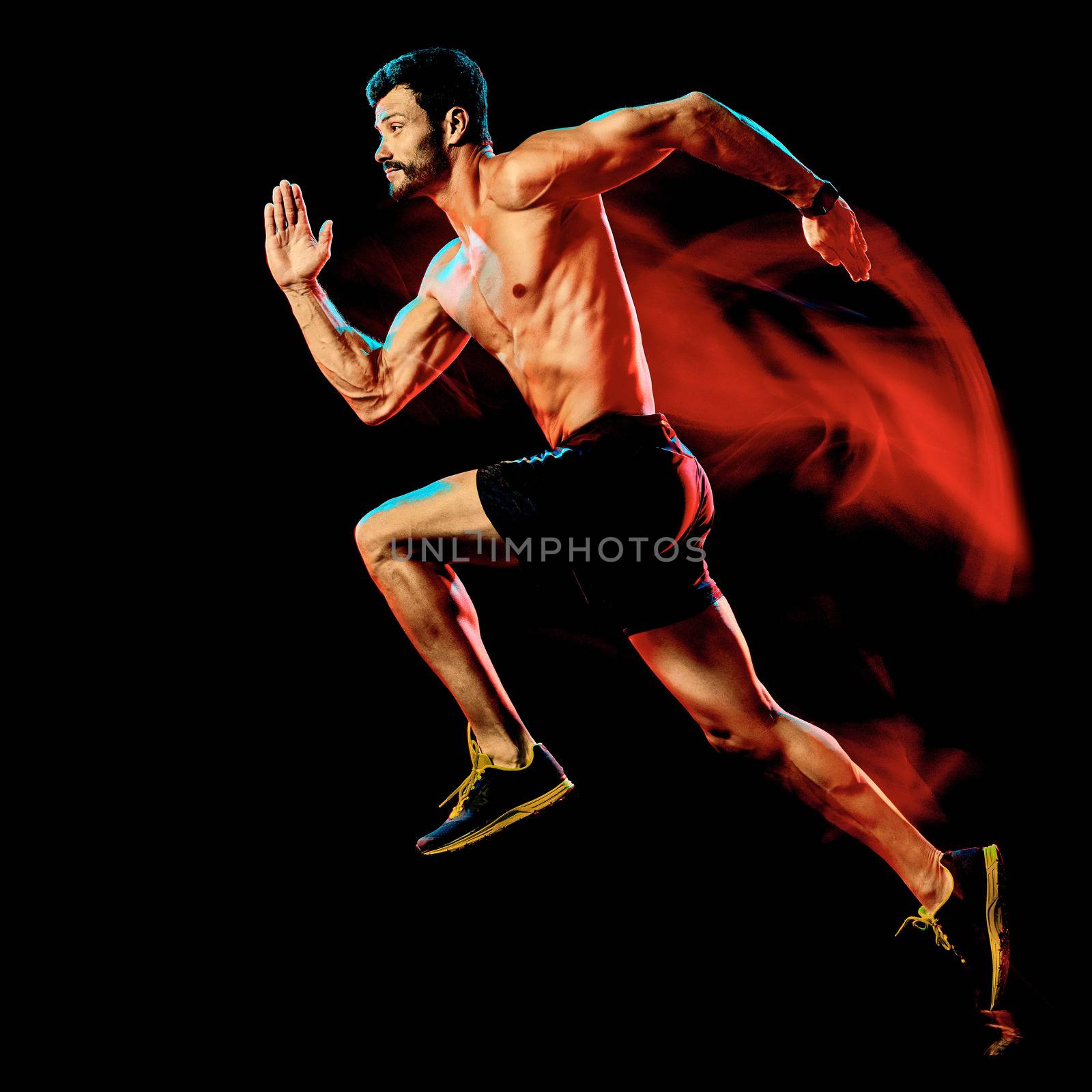 one caucasian topless muscular mature man runner. running jogger jogging isolated on black background with light painting speed mouvement effect