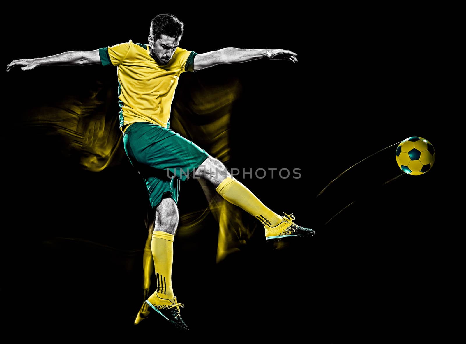 one caucasian soccer player man isolated on black background with light painting speed effect