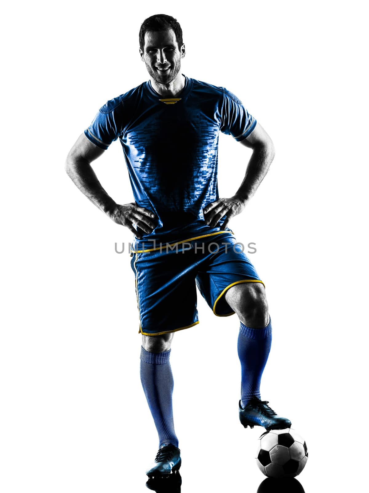 one caucasian soccer player man standing smiling in silhouette isolated on white background
