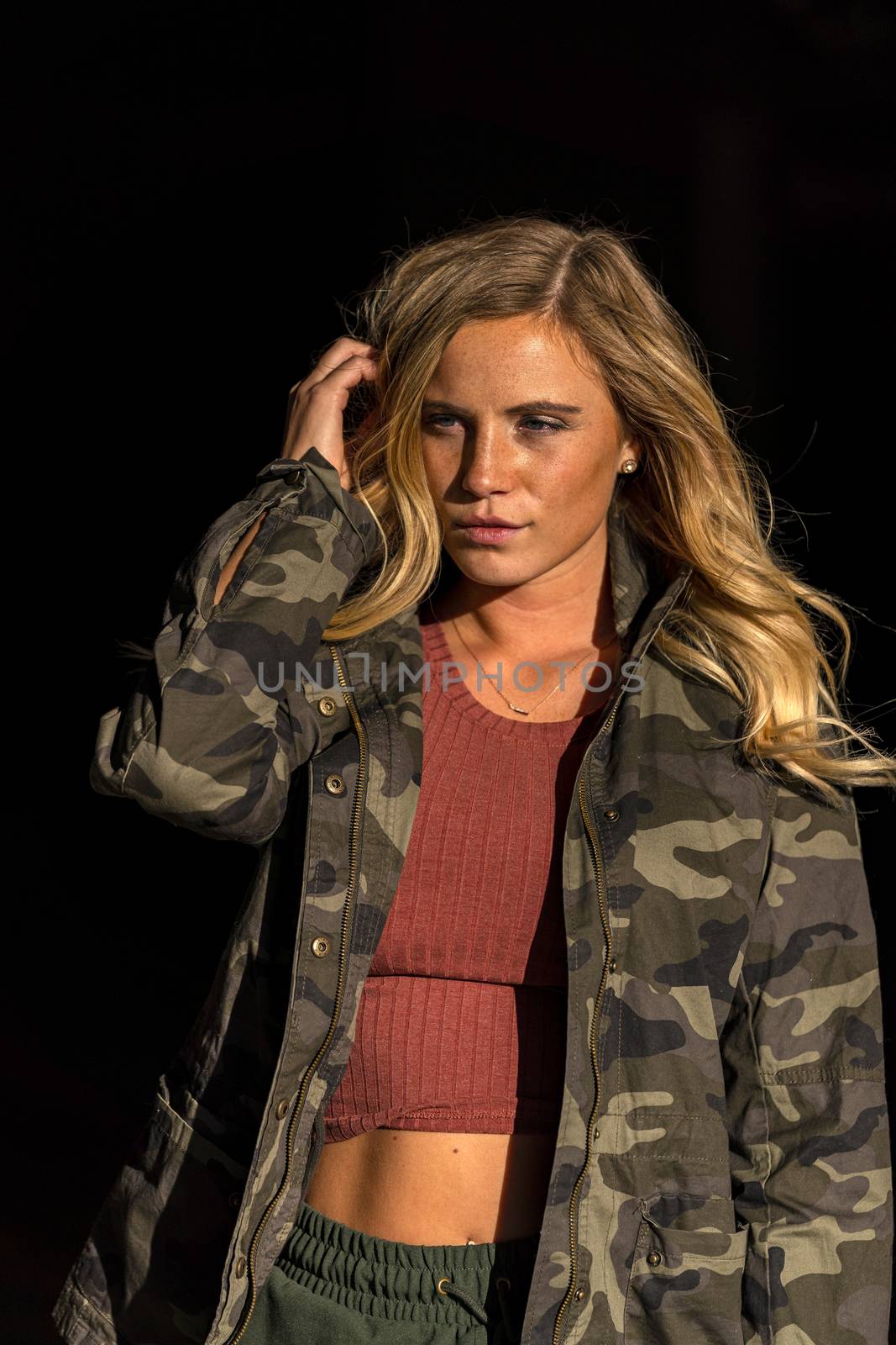 A gorgeous blonde model poses in a parking deck on an autumn day