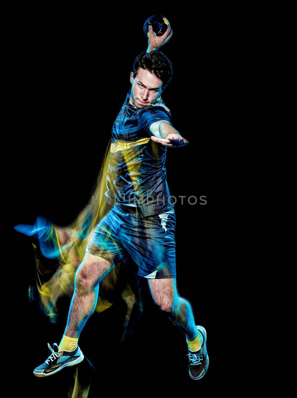 one caucasian handball player young man isolated on black background with speed light painting effect motion blur