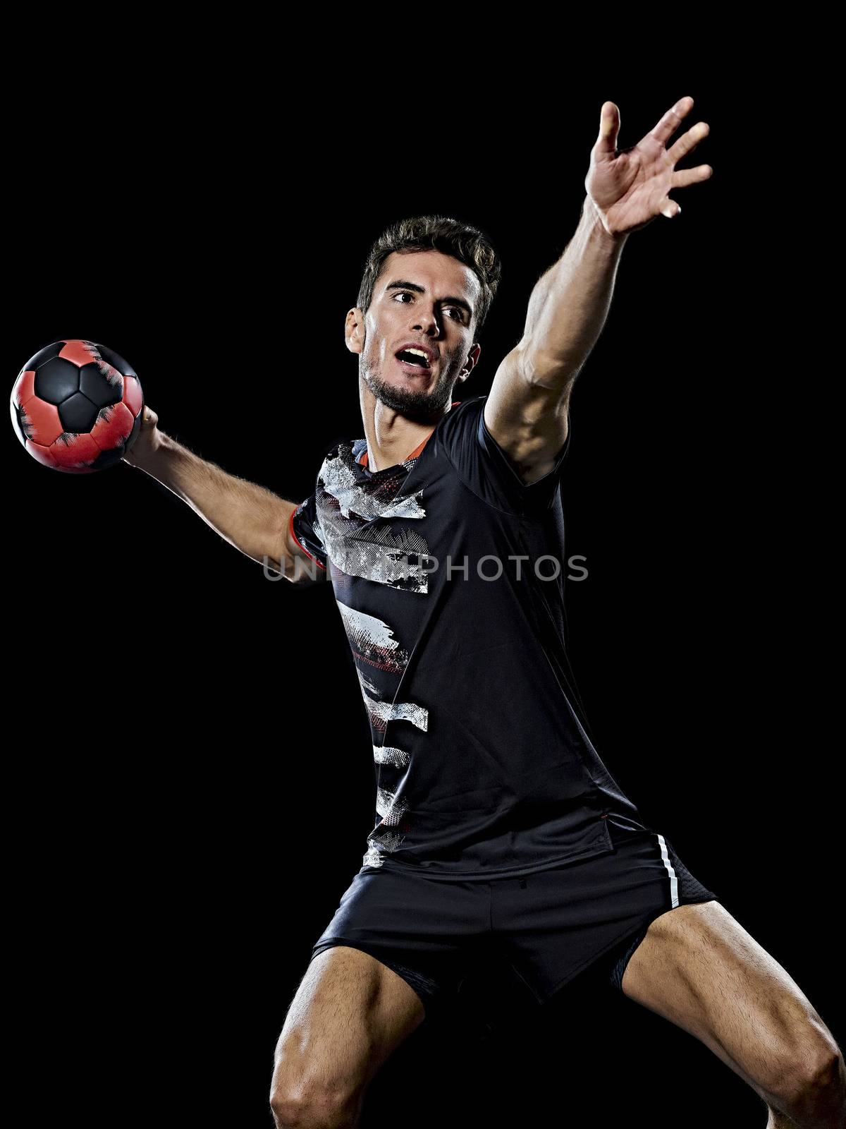 caucasian young handball player man isolated black background by PIXSTILL