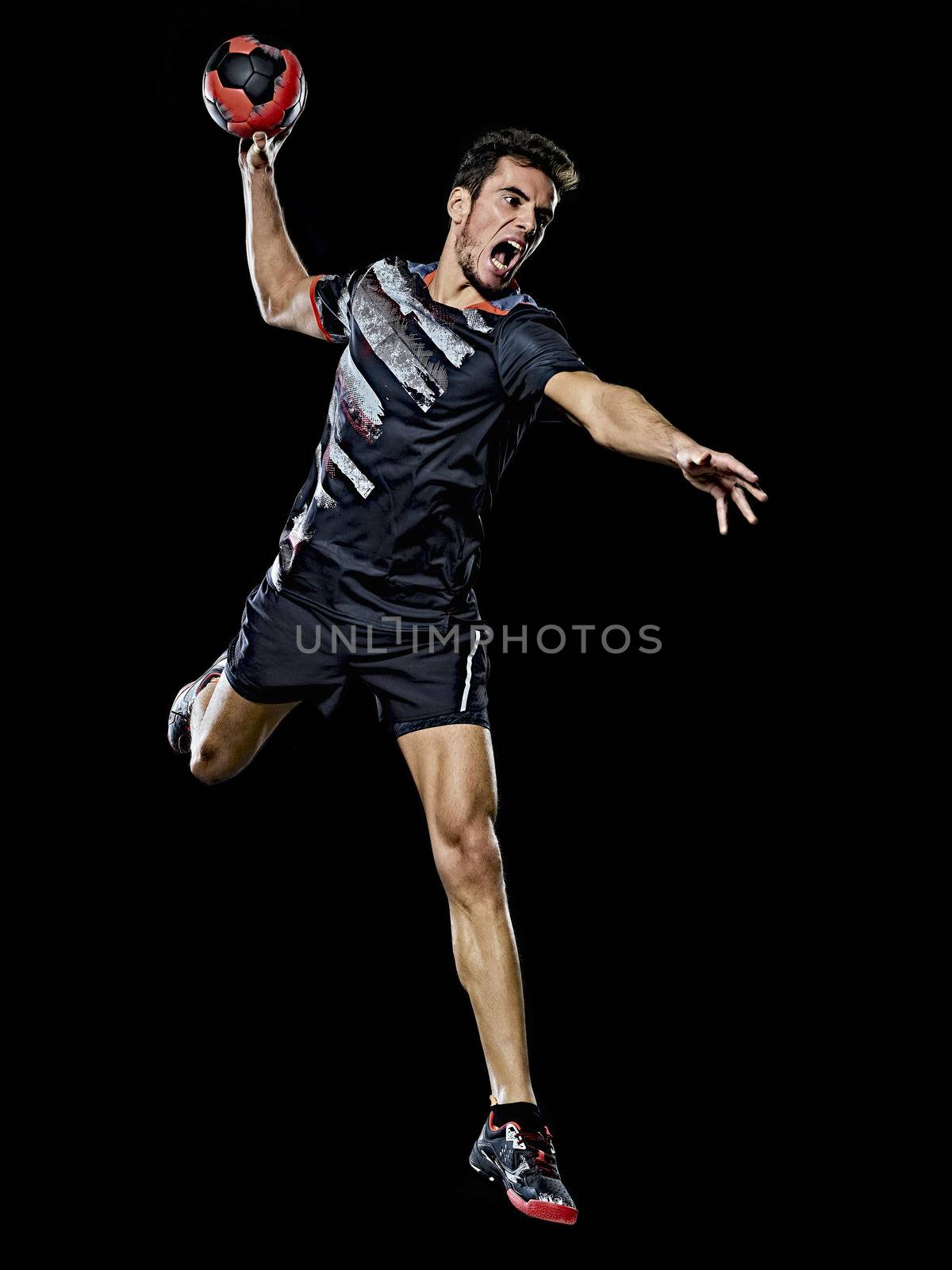 caucasian young handball player man isolated black background by PIXSTILL