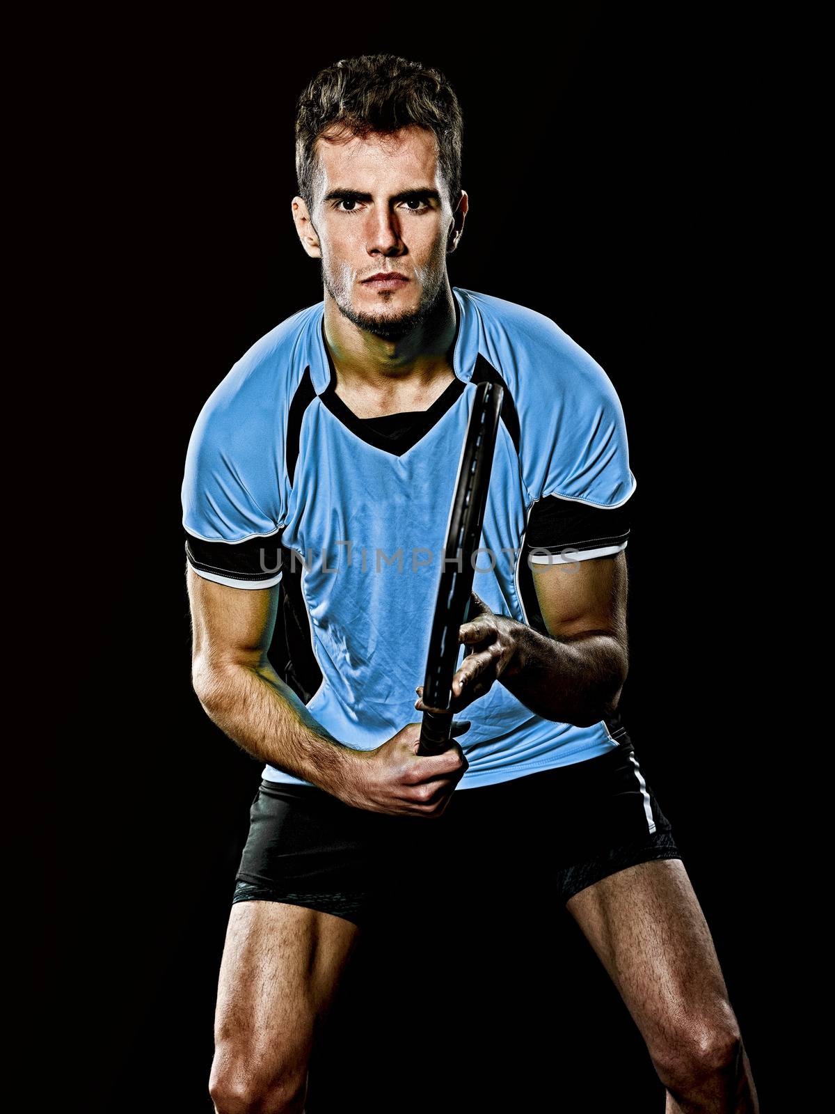 one caucasian young player tennis man in studio isolated on black background