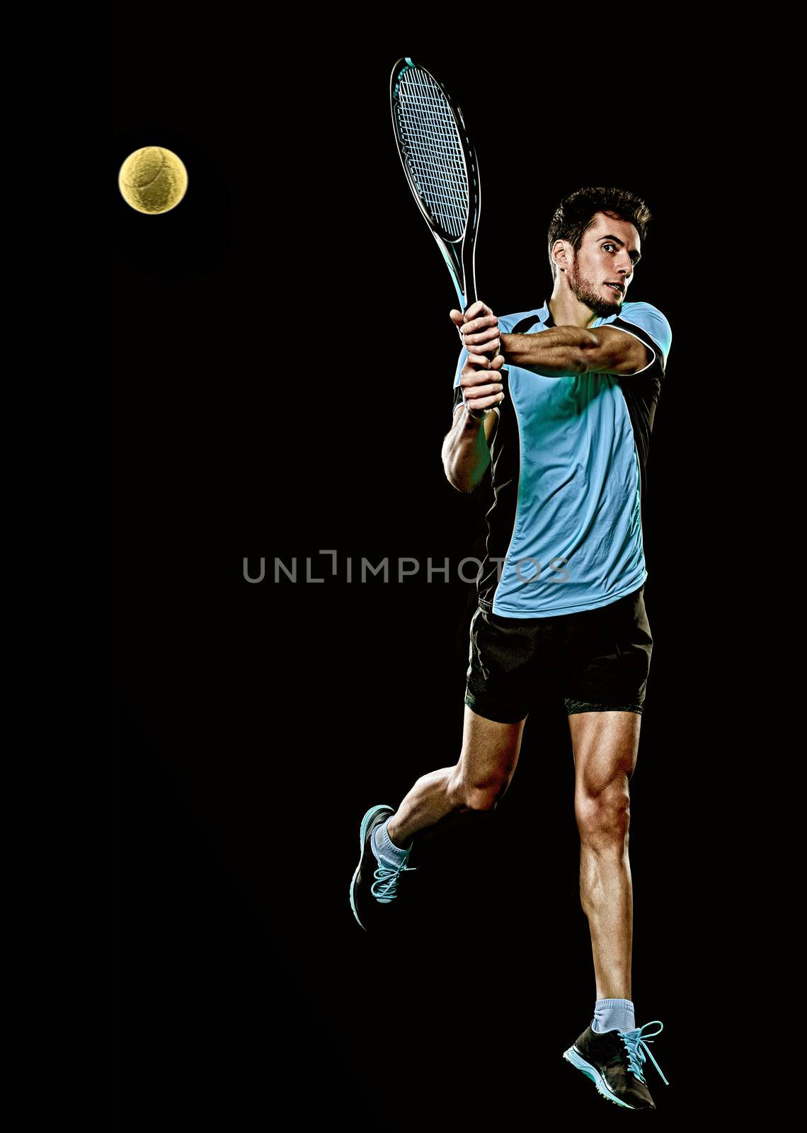 caucasian young tennis player man isolated black background by PIXSTILL