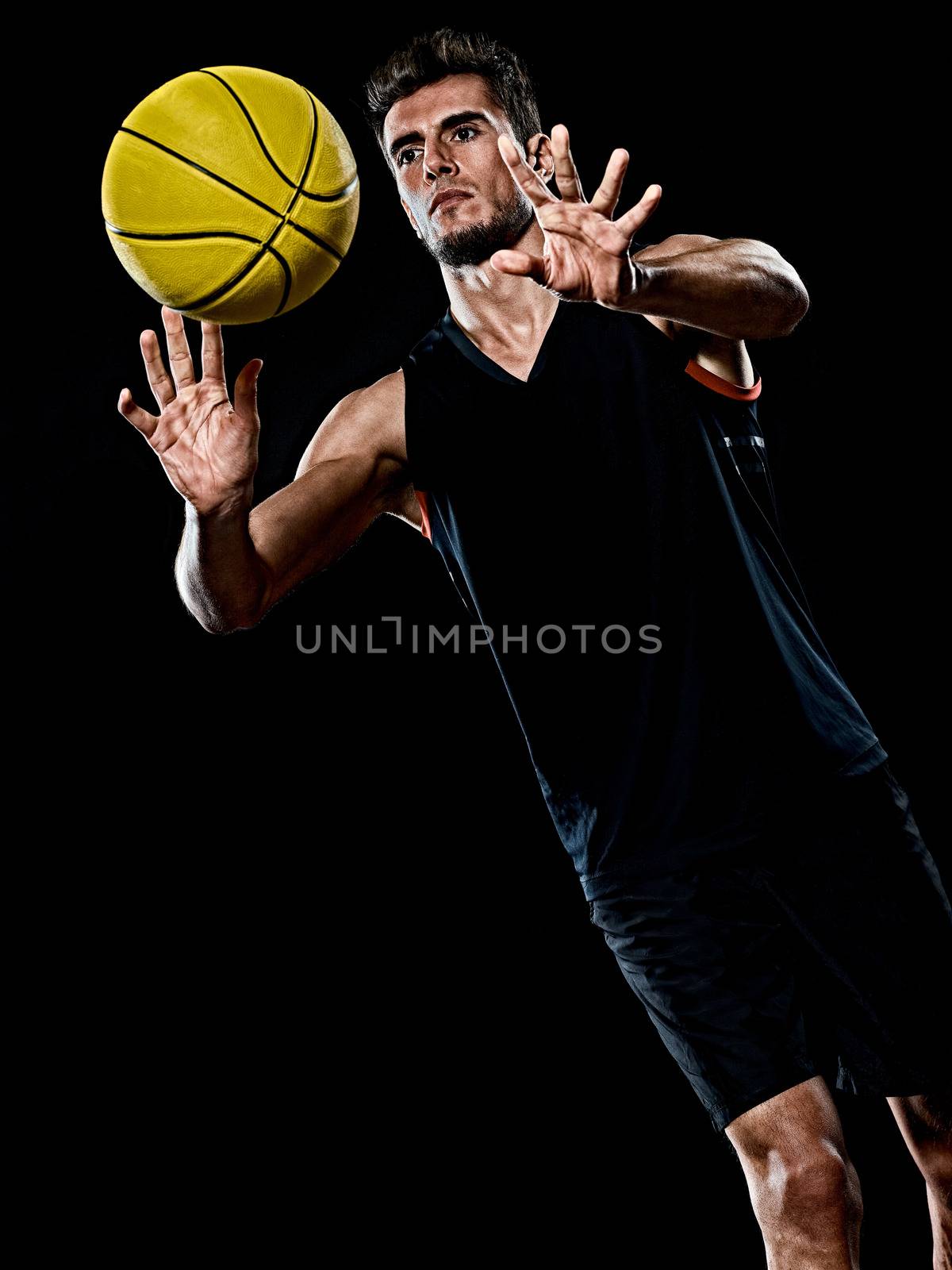 caucasian young basketball player manisolated black background by PIXSTILL