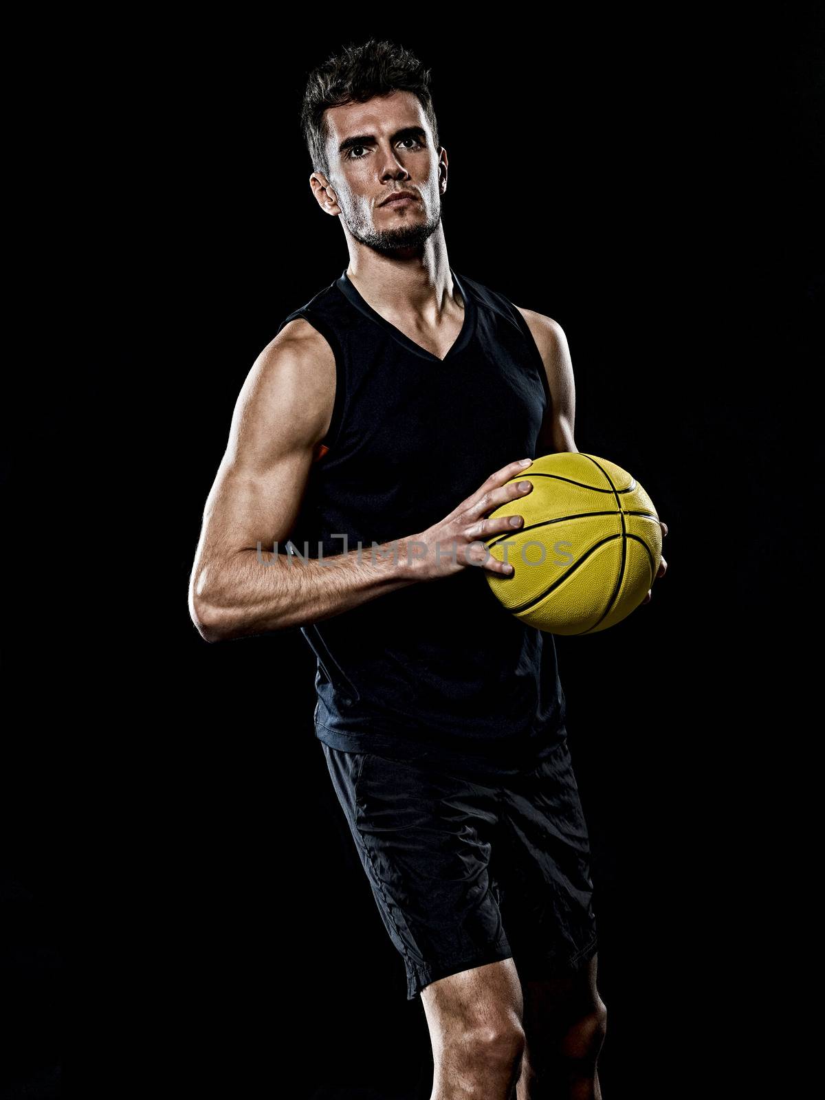 caucasian young basketball player manisolated black background by PIXSTILL