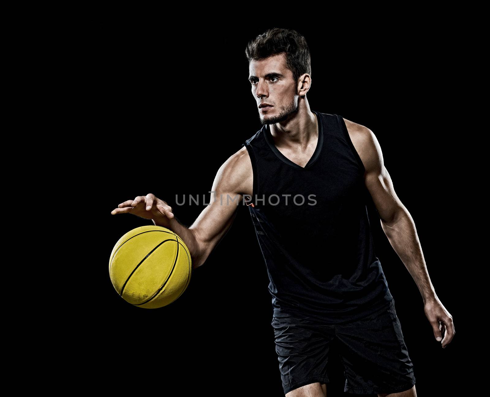 caucasian young basketball player manisolated black background by PIXSTILL