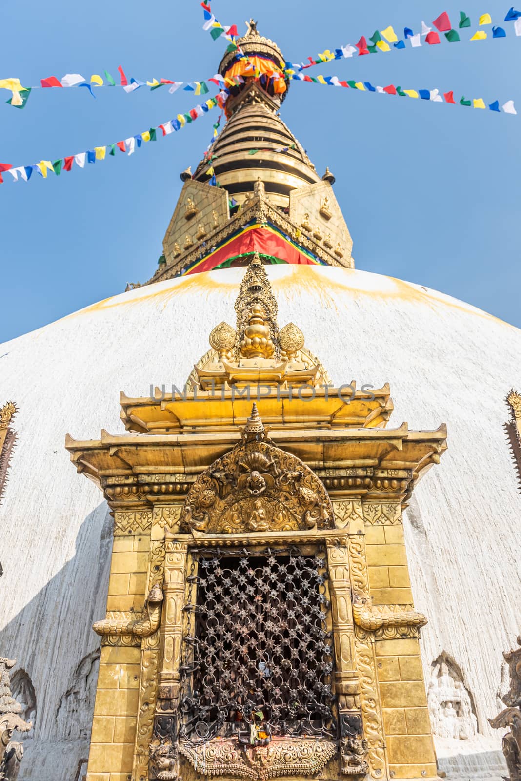 Tower of the Boudhanath Stupa decorated with flags in Kathmandu, Nepal. by rayints