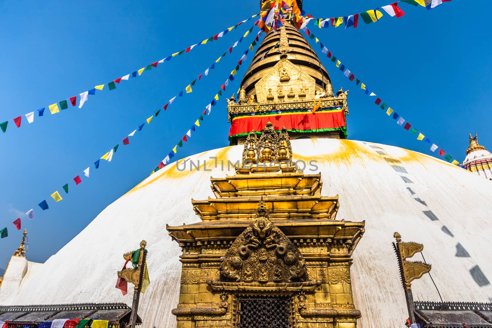 Tower of the Boudhanath Stupa decorated with flags in Kathmandu, Nepal. by rayints