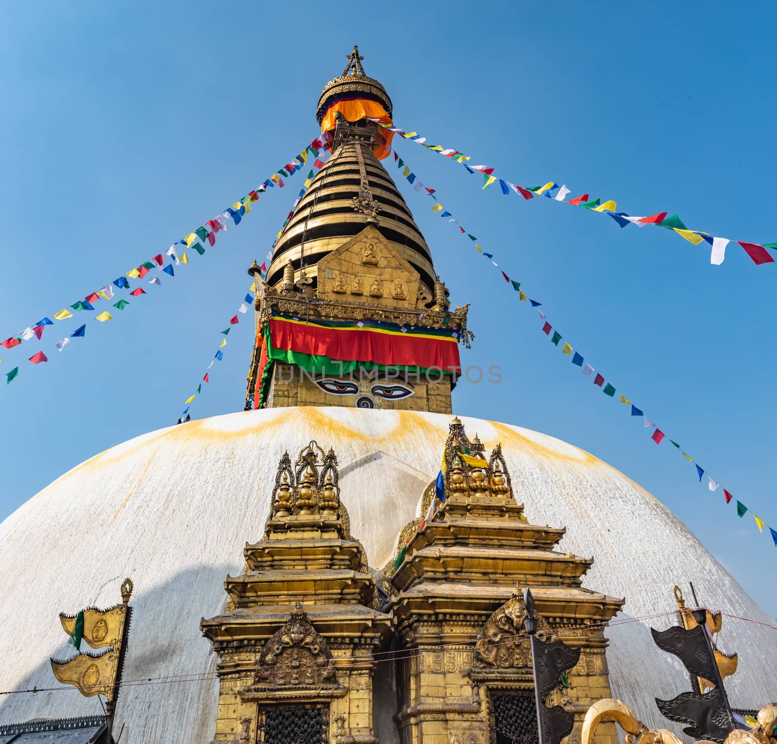 Tower of the Boudhanath Stupa decorated with flags in Kathmandu, Nepal. by rayints