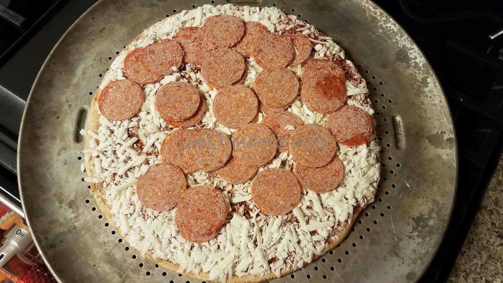 frozen pepperoni meat on pizza on metal baking tray by stockphotofan1