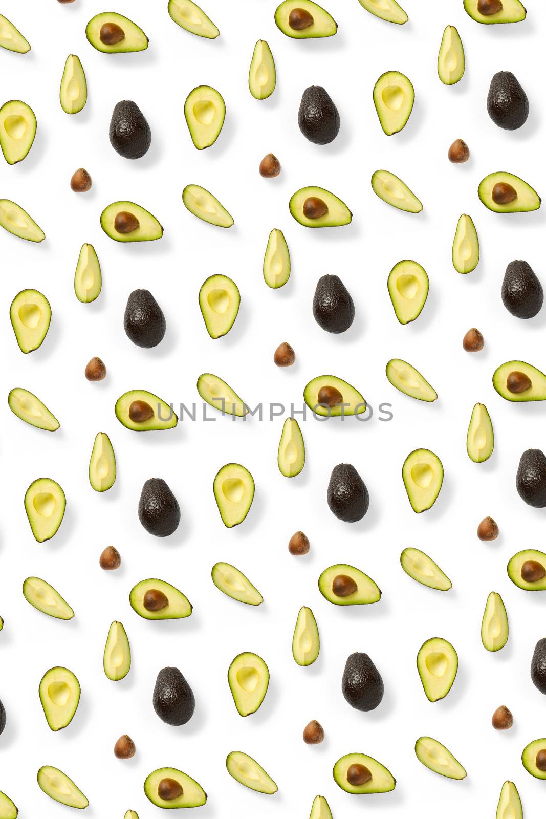 Avocado. Background made from isolated Avocado pieces on white background. Flat lay of fresh ripe avocados and avacado pieces