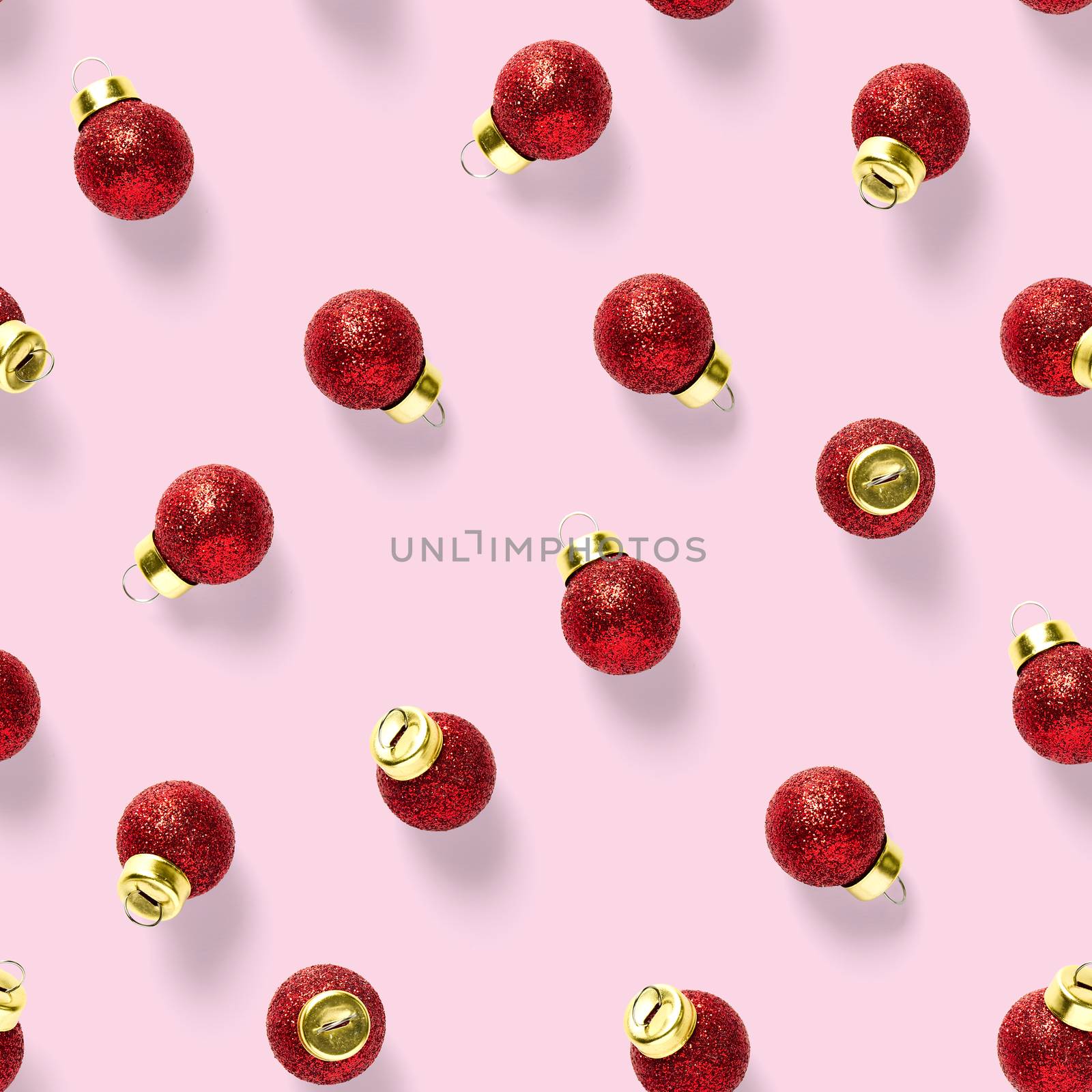 Seamless pattern with red Christmas decorations on pink background. Christmas red ornaments Seamless pattern. Christmas abstract background made from balls.