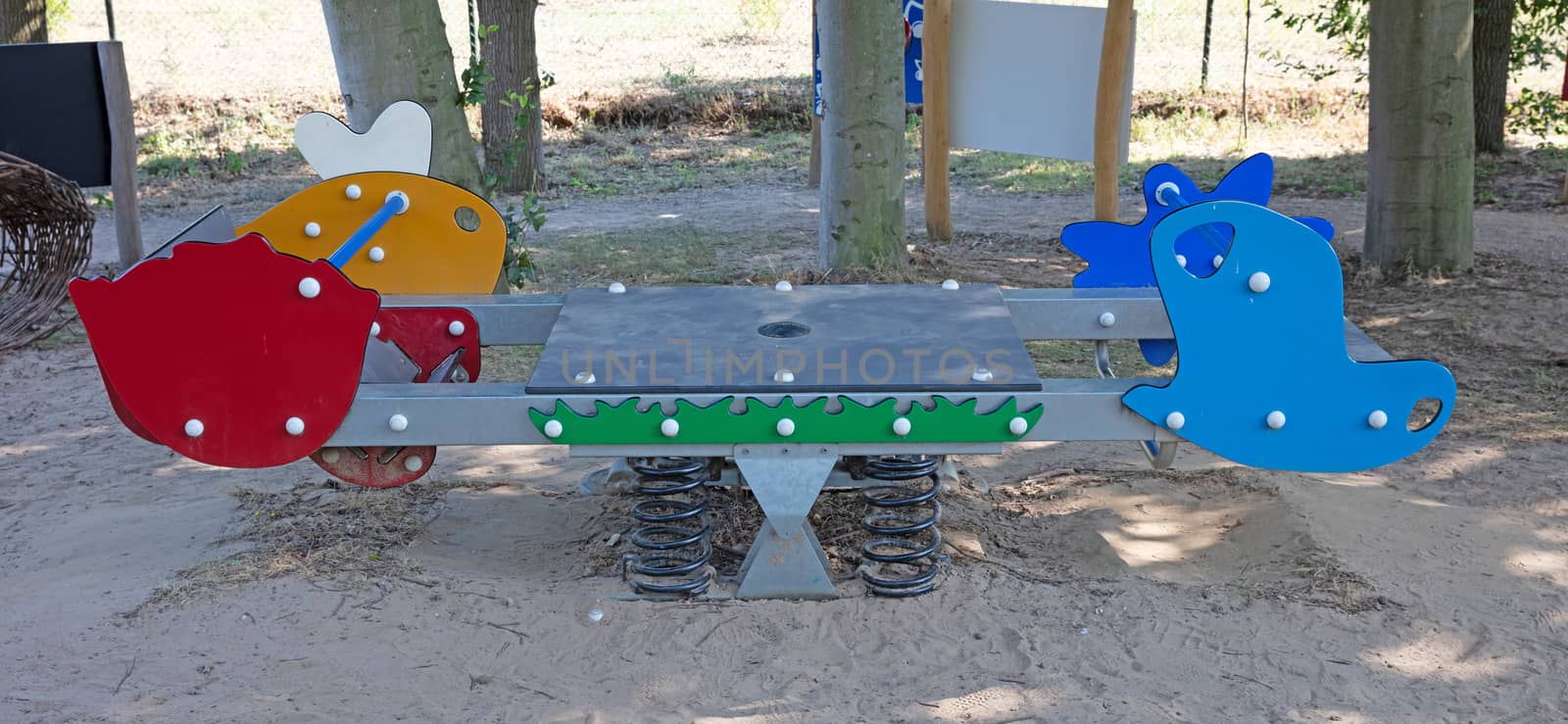Modern colorful children playground in public park by michaklootwijk