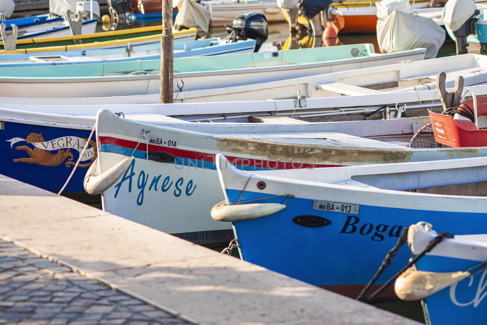 Colored boats moored on Bardolino port in Italy 4 by pippocarlot