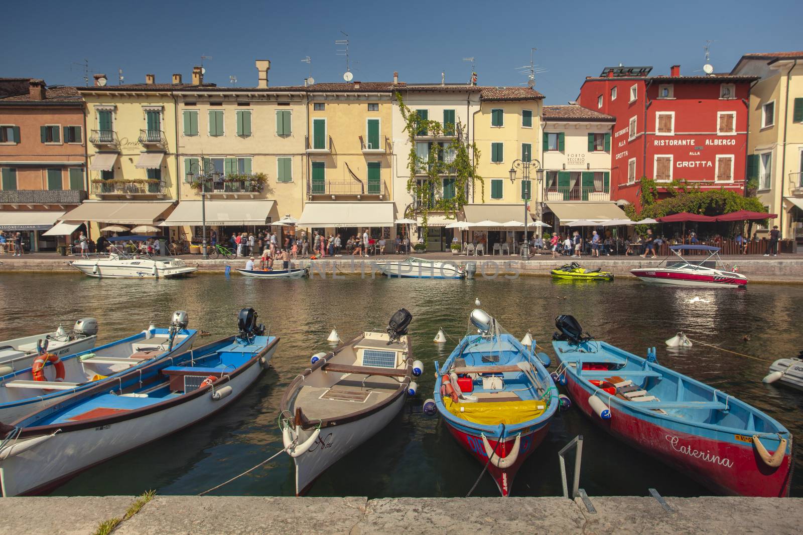 Colored boats moored in Lazise on Garda Lake by pippocarlot