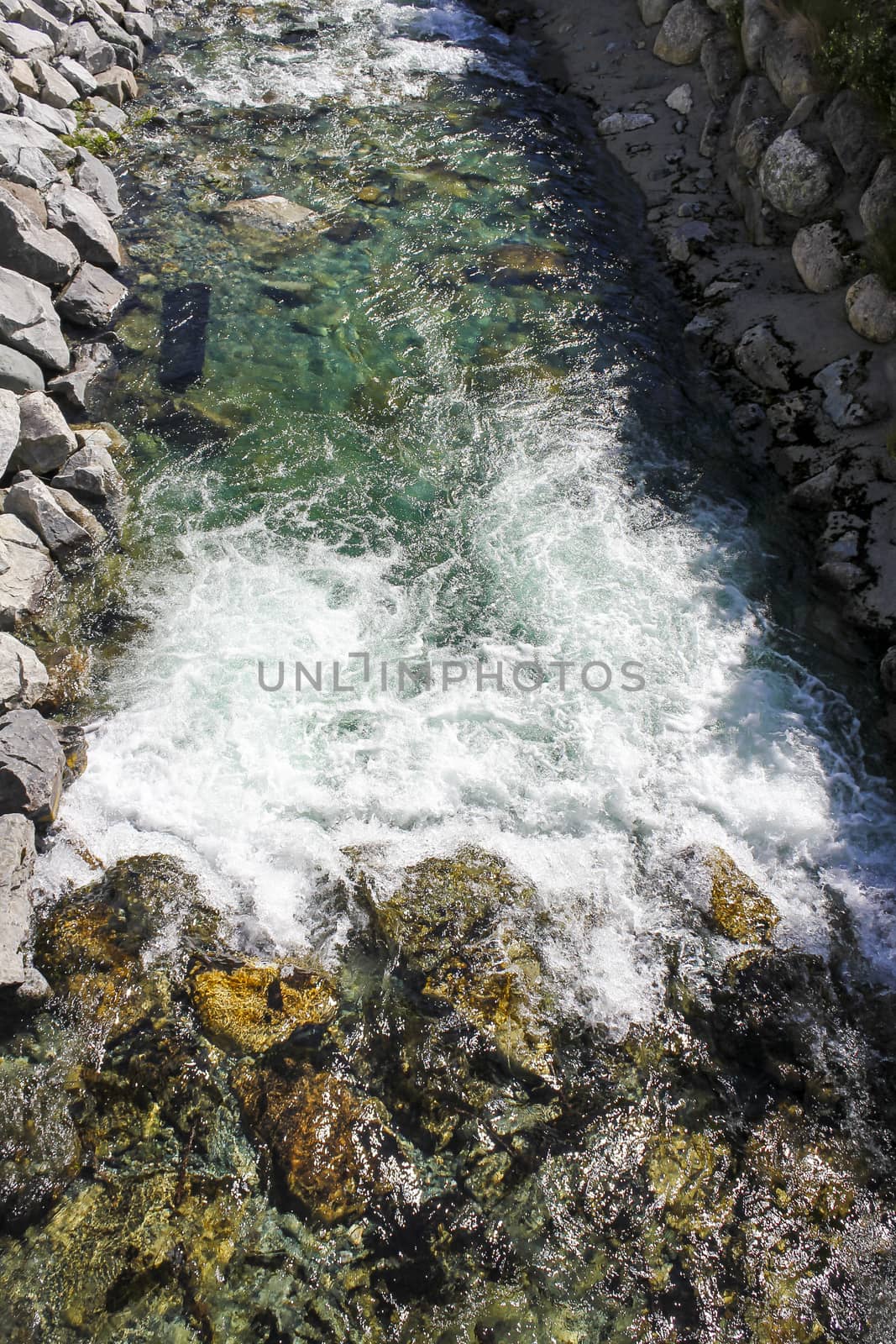 Flowing beautiful turquoise river lake with stones in Hemsedal, Viken, Buskerud, Norway.