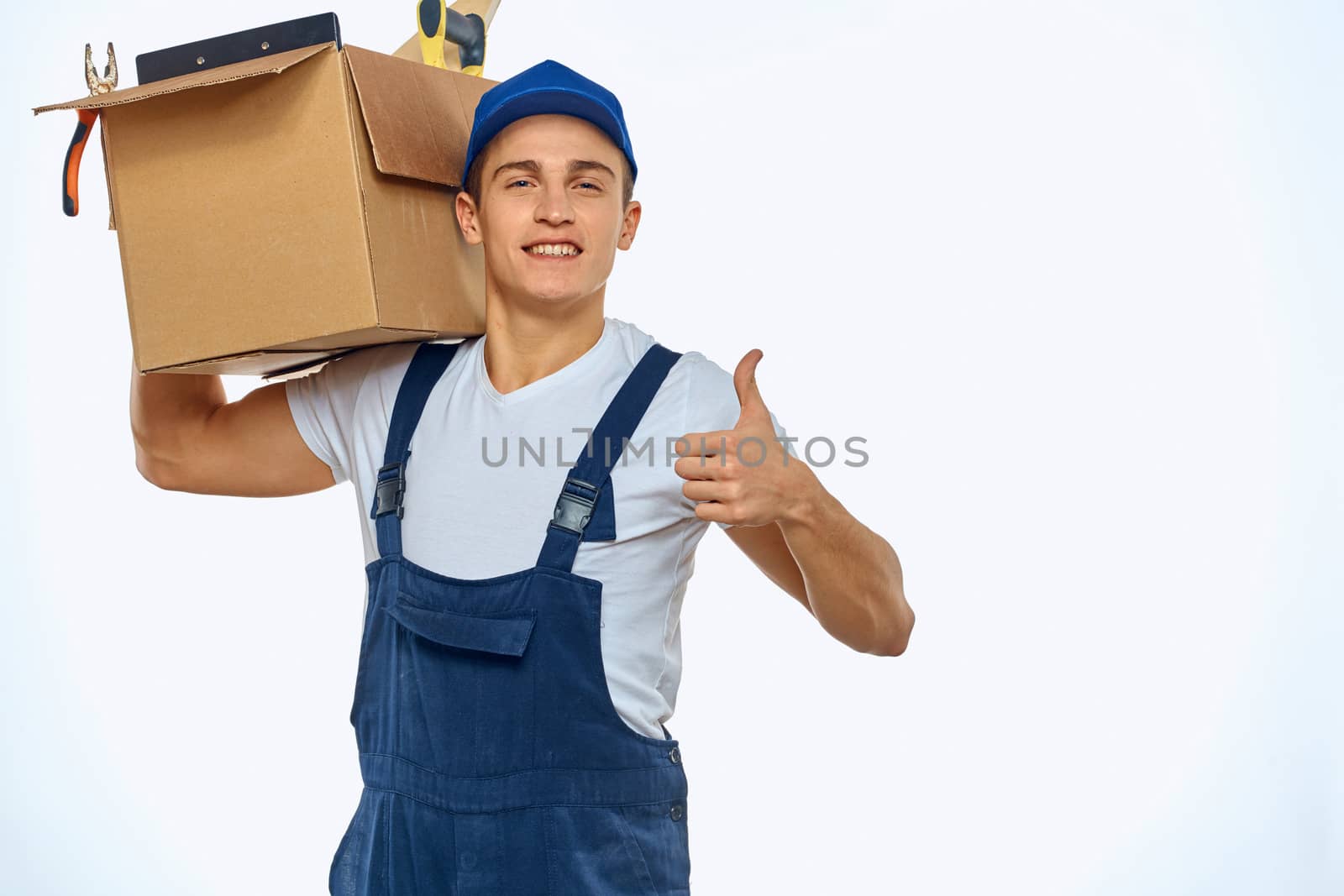 A man in a working uniform with a box in his hand loading a delivery service. High quality photo