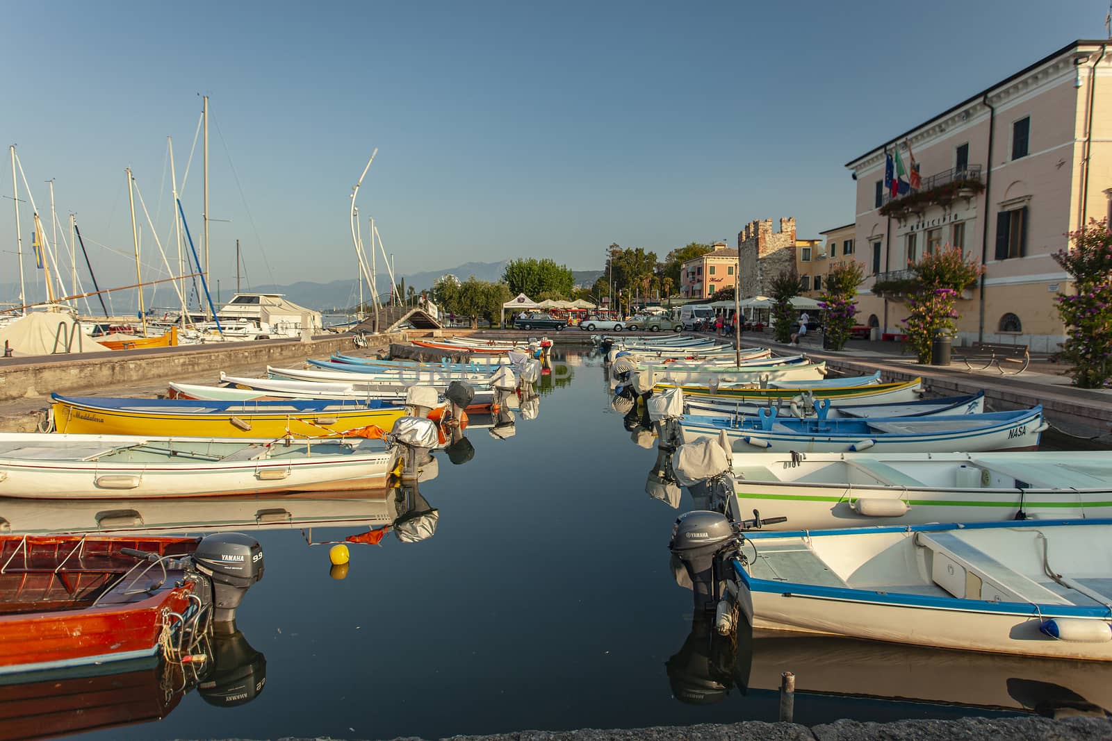 Port on Garda Lake of Bardolino with colored boats by pippocarlot