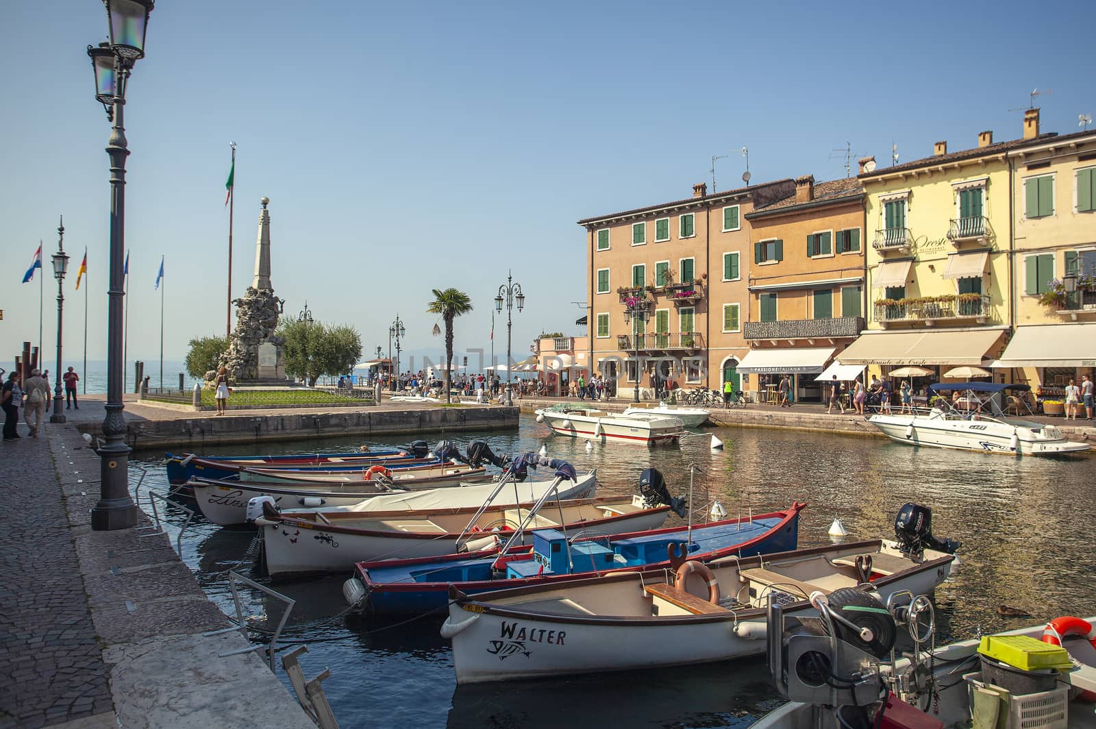 Dogana Veneta and Porticciolo in Lazise, in Italy with colored boats 11 by pippocarlot
