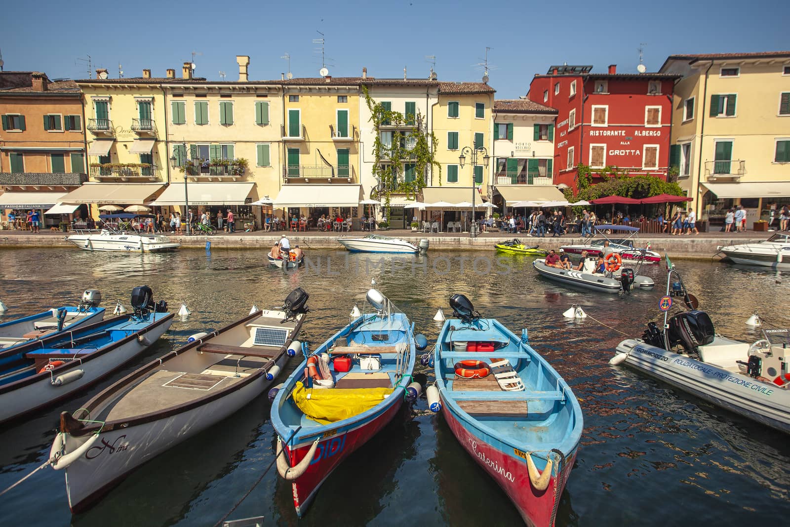 Dogana Veneta and Porticciolo in Lazise, in Italy with colored boats 6 by pippocarlot